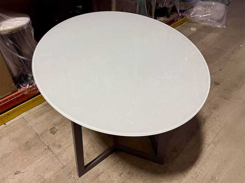 Modern white round table with black metal legs for contemporary interior design.