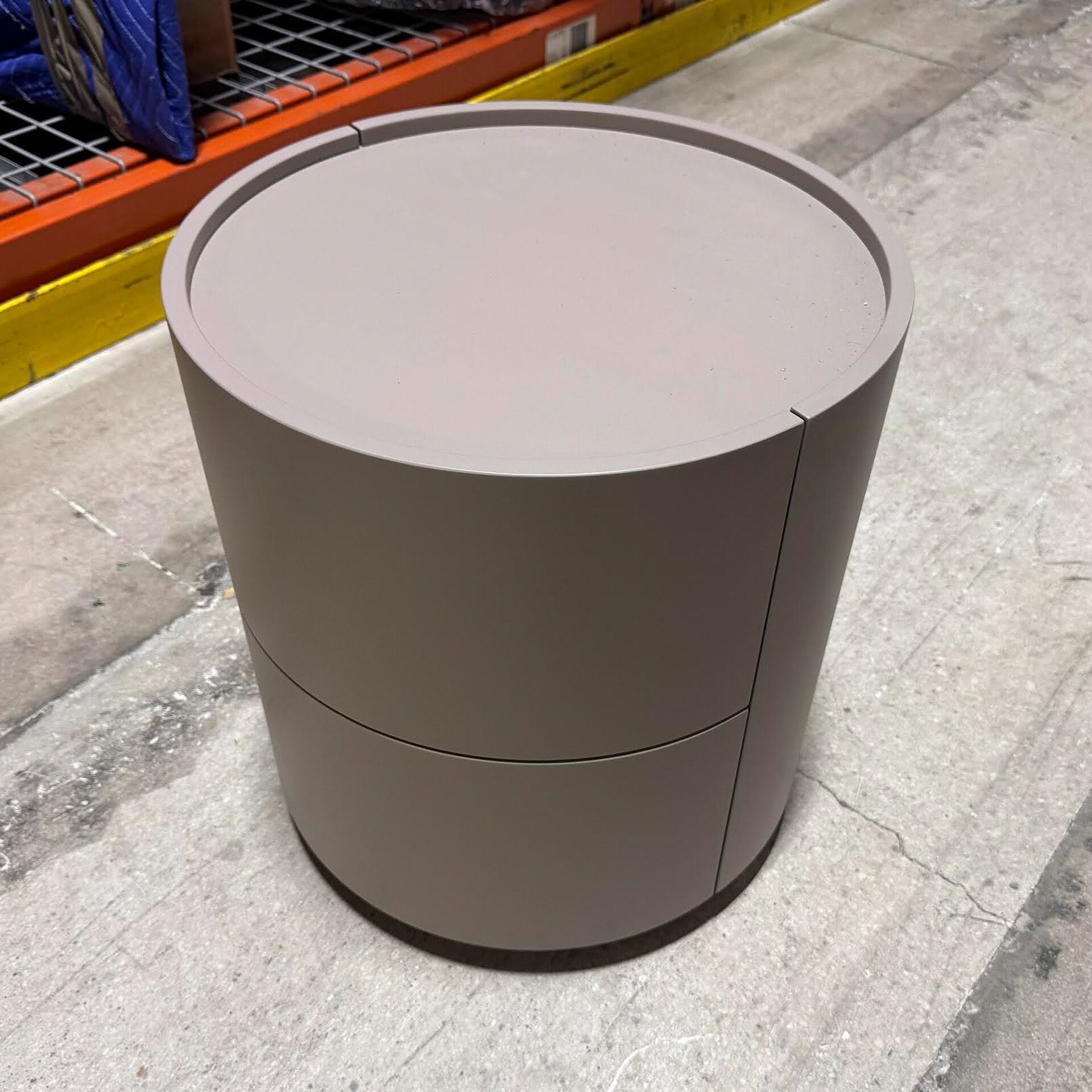 Contemporary grey round nightstand with sleek design for bedroom decor.