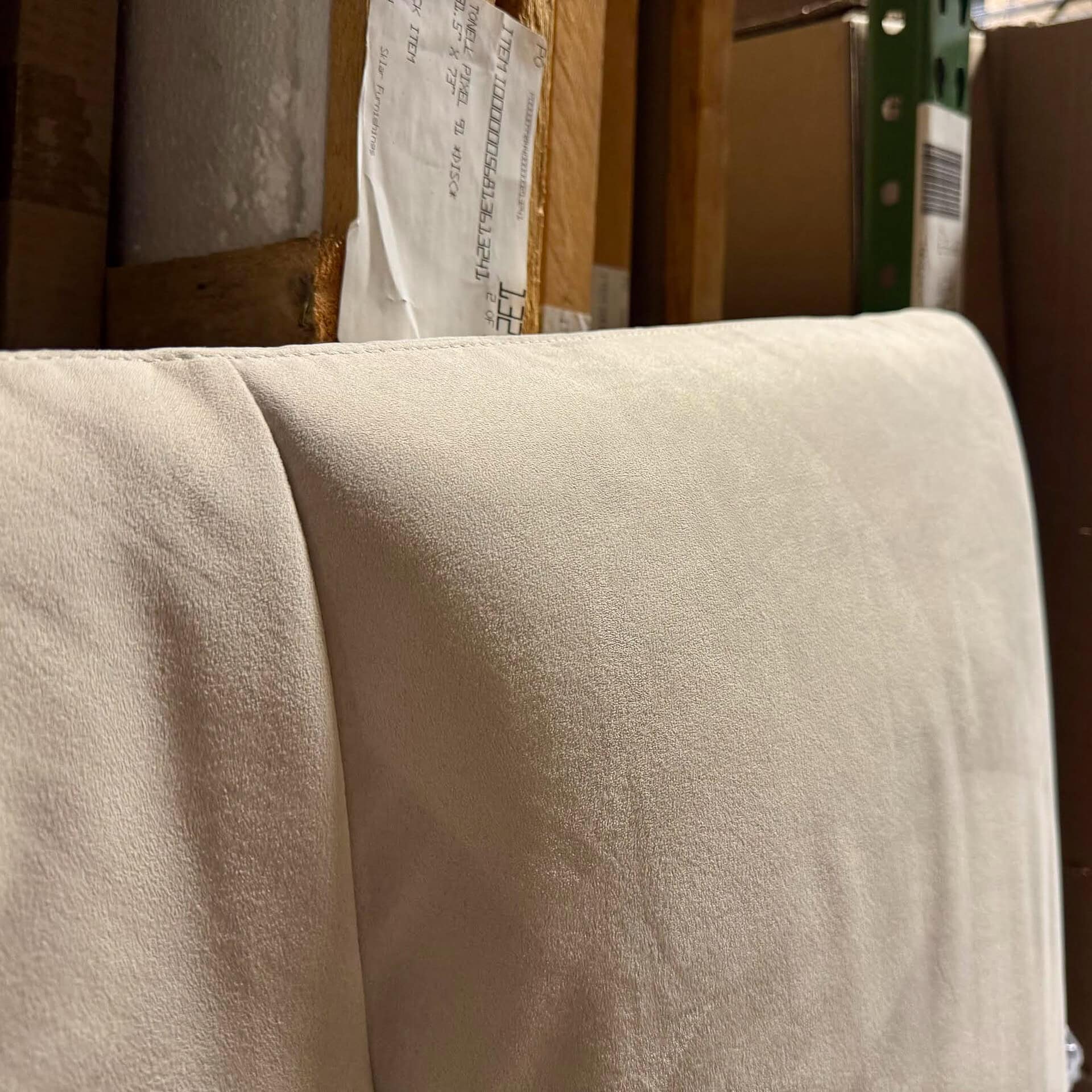 Upholstered headboard in a neutral beige fabric, perfect for modern bedroom decor.