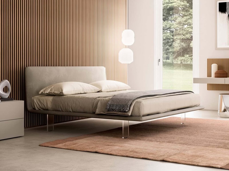 Modern bedroom with a wooden accent wall, large window, and minimalist furniture.