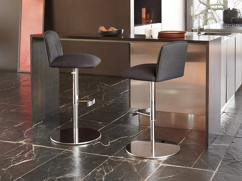 Bar stools at modern kitchen island for casual dining and socializing.