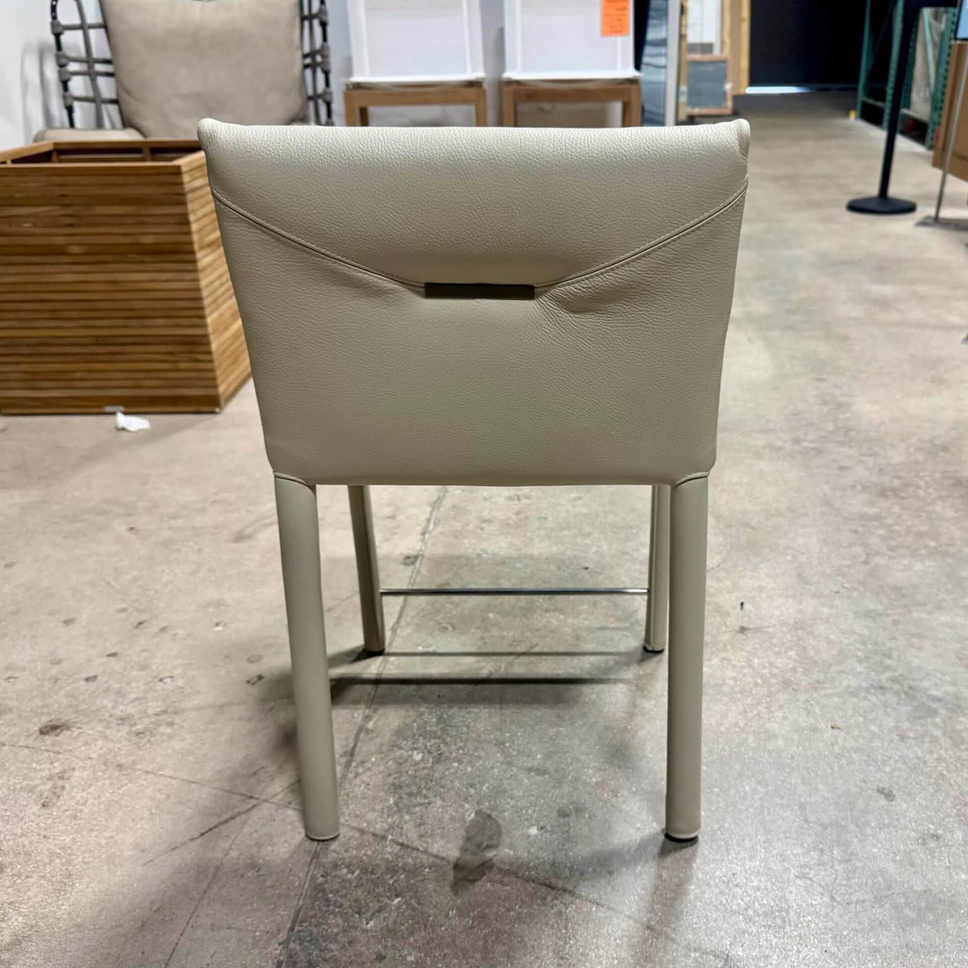 Elegant beige upholstered dining chair with metal legs, ideal for contemporary dining rooms.