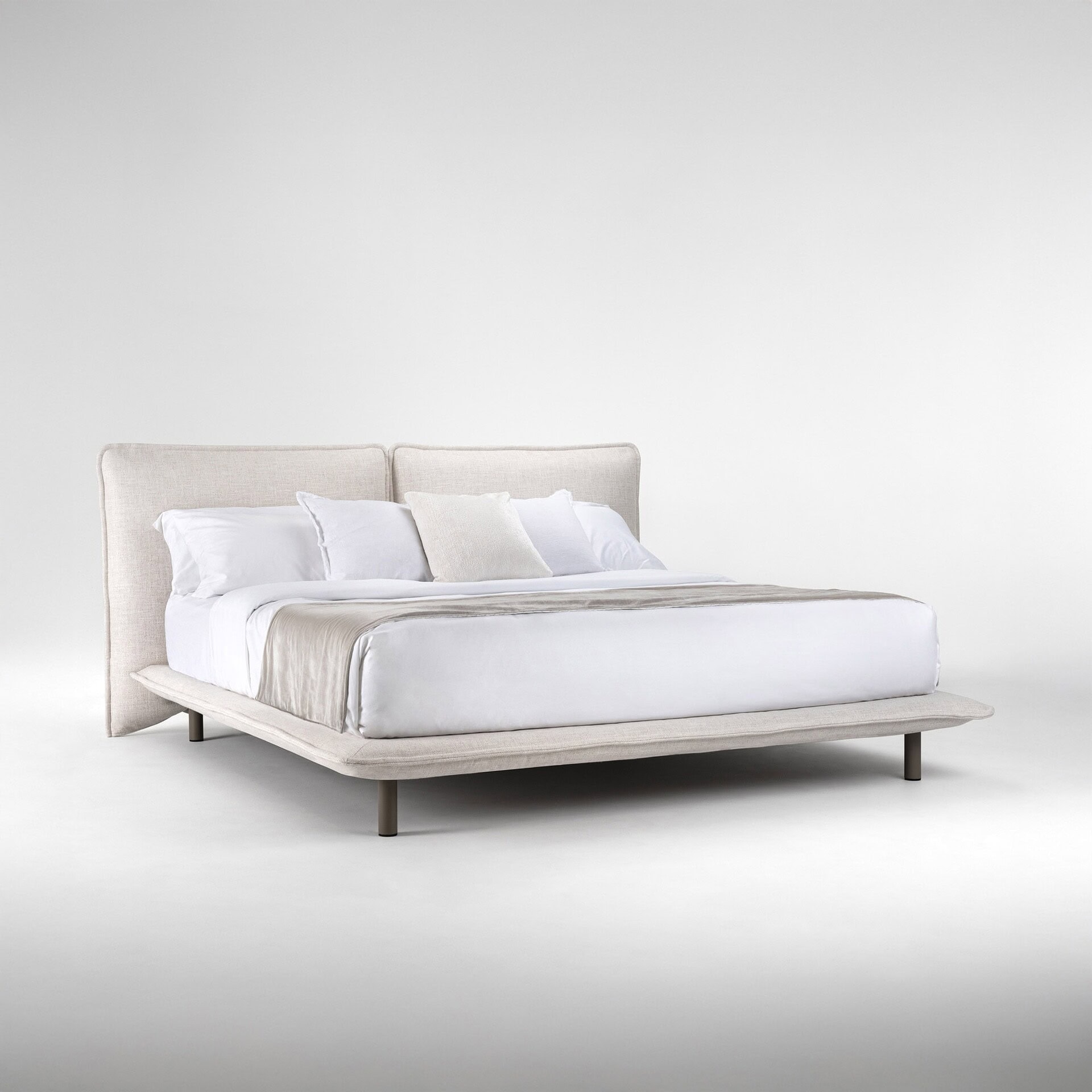 Elegant modern bed with neutral fabric upholstery and sleek design for stylish bedrooms.