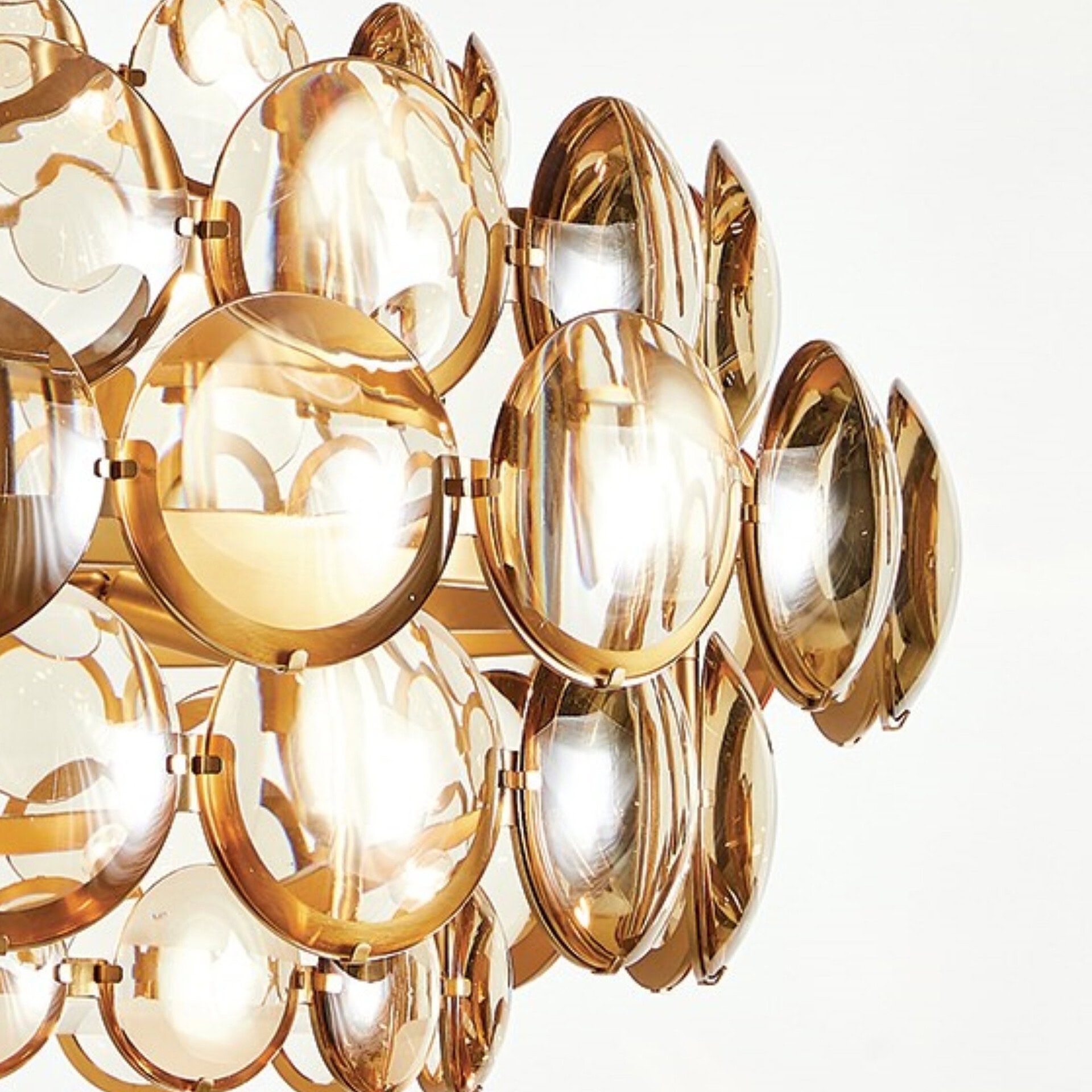 Gold mirror wall art with circular design for contemporary interiors.