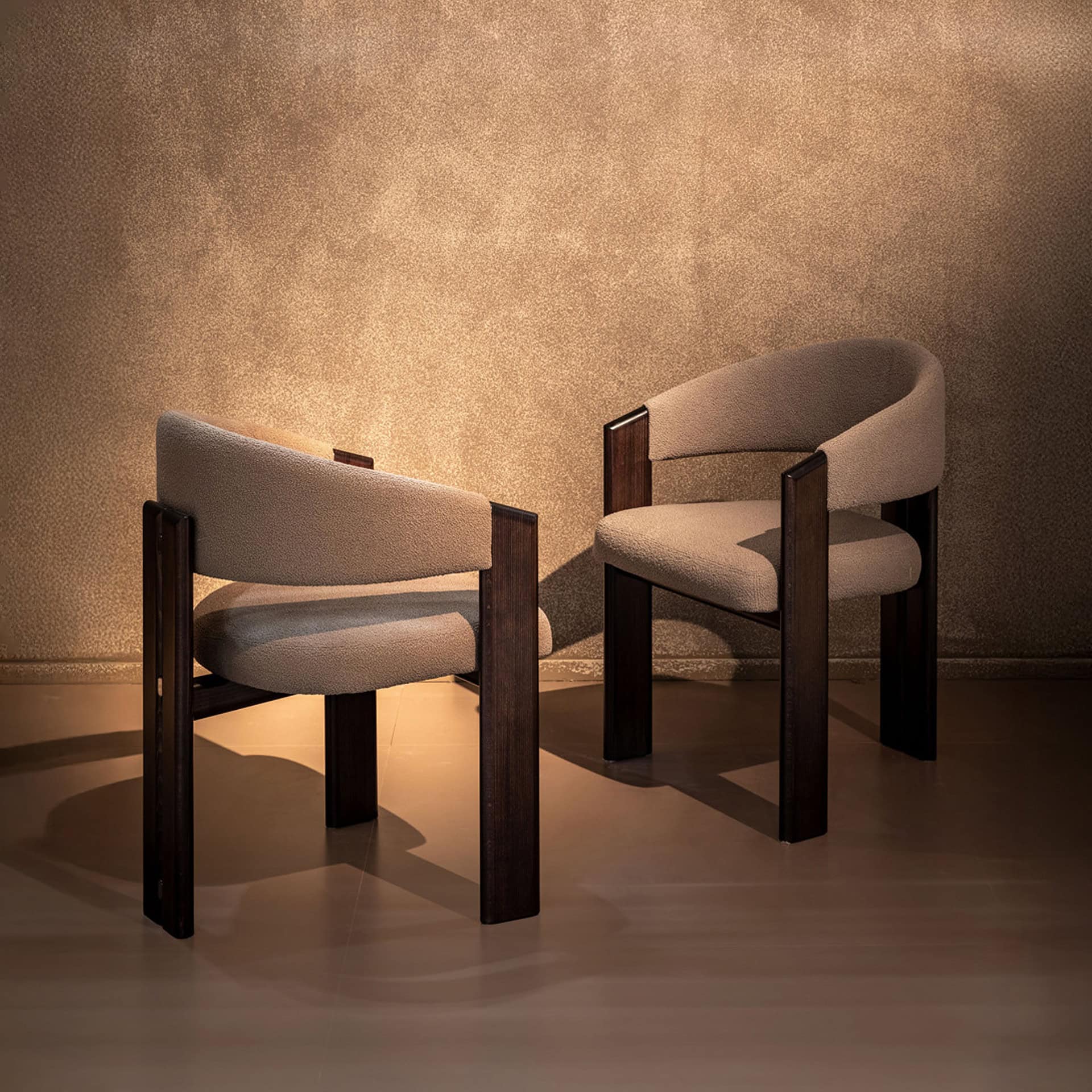 Upholstered armchairs with wooden frames, ideal for stylish living room decor.