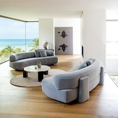 Contemporary living room with ocean view, stylish sofas, and modern decor.