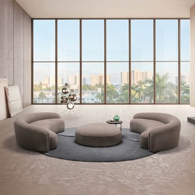 Elegant contemporary lounge furniture set in a spacious room with large windows and city view.