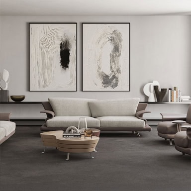 Elegant living room featuring a contemporary sofa and two large abstract art pieces on the wall.