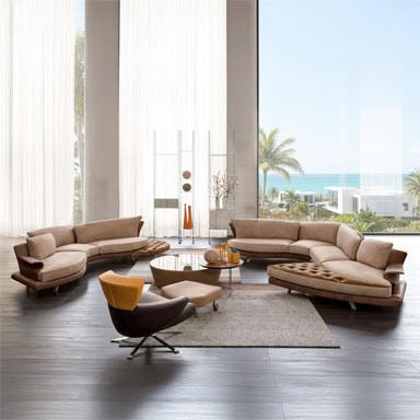 Elegant living room featuring marquee-style sofas and chairs with ocean view backdrop.