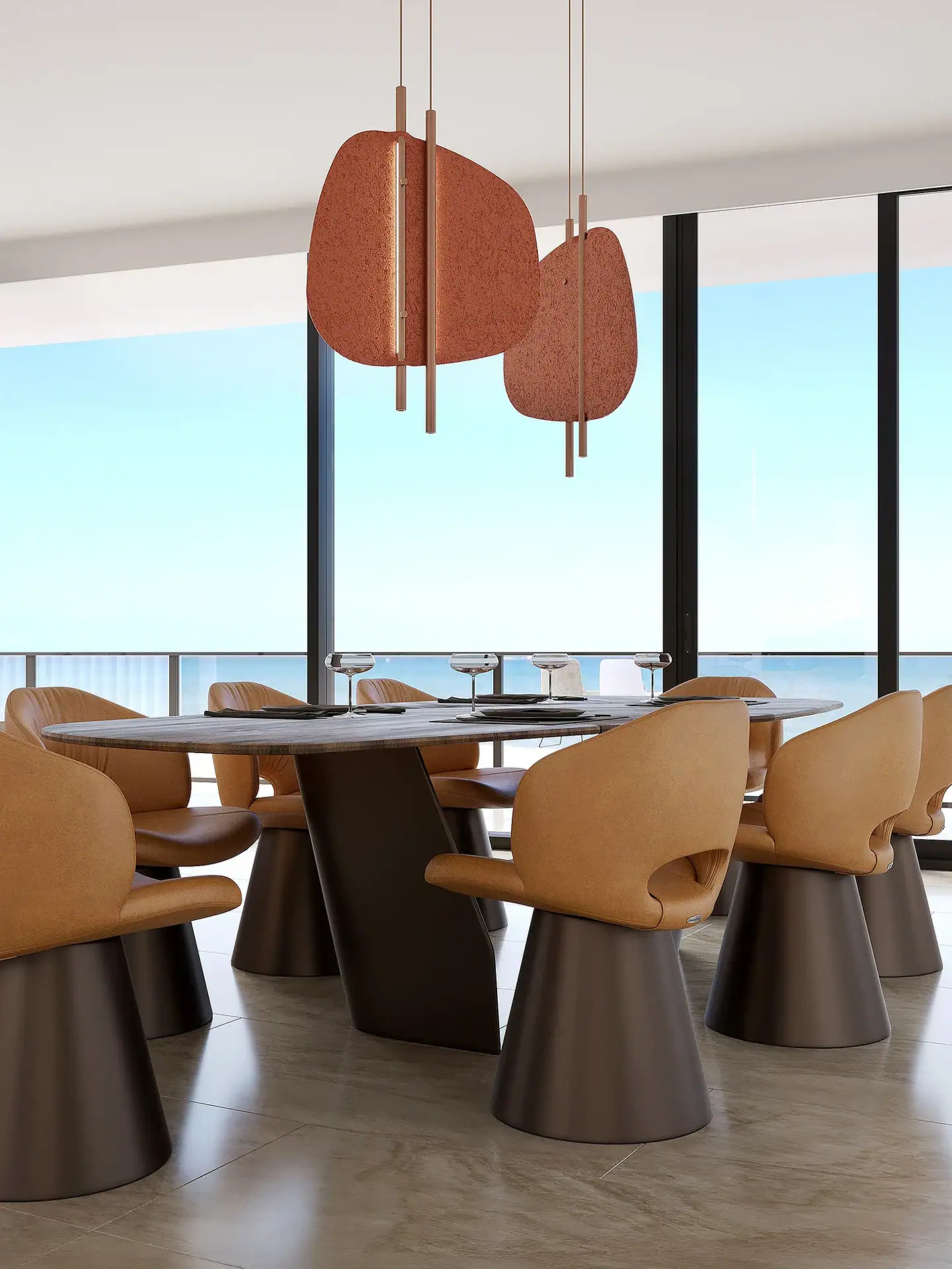 A modern dining room with an oval table, tan leather chairs, and unique pendant lights, overlooking a blue ocean through floor-to-ceiling windows.