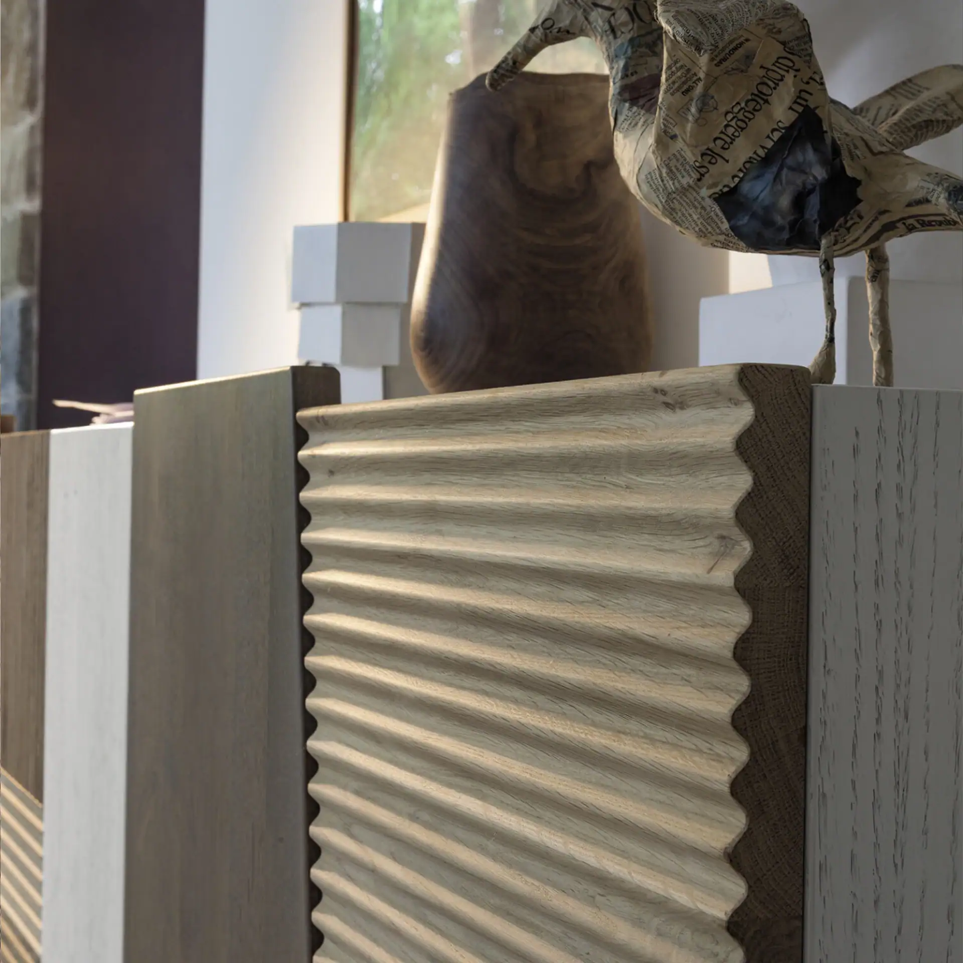Close-up of the Zero.16 sideboard with textured wood finish and decorative vase.
