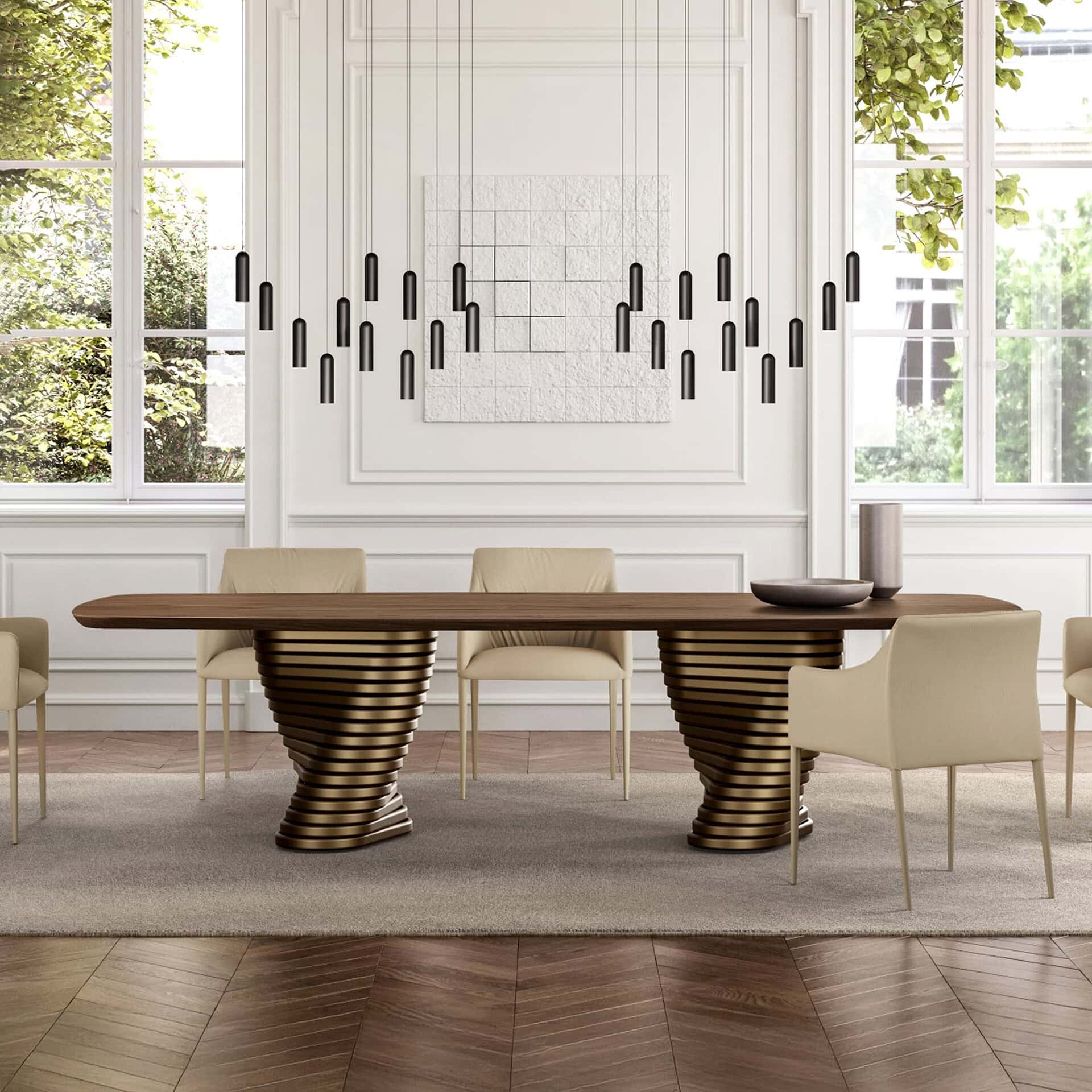 Contemporary dining table with sculptural base in a bright, elegant dining room setting.