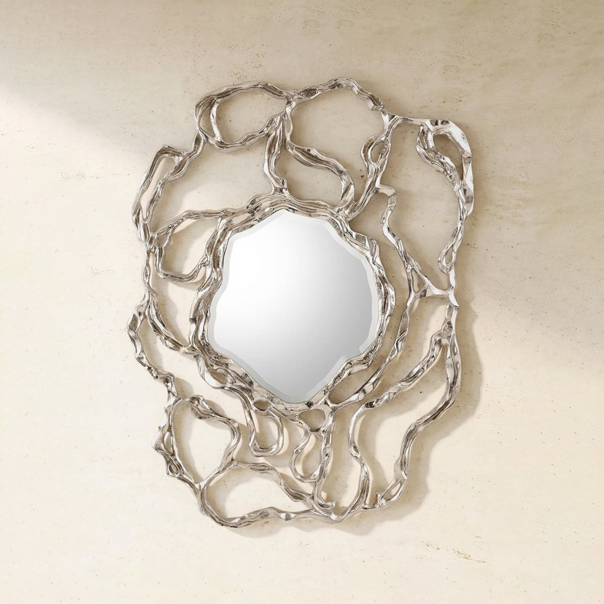 Elegant metallic wall mirror with an artistic, organic frame design.