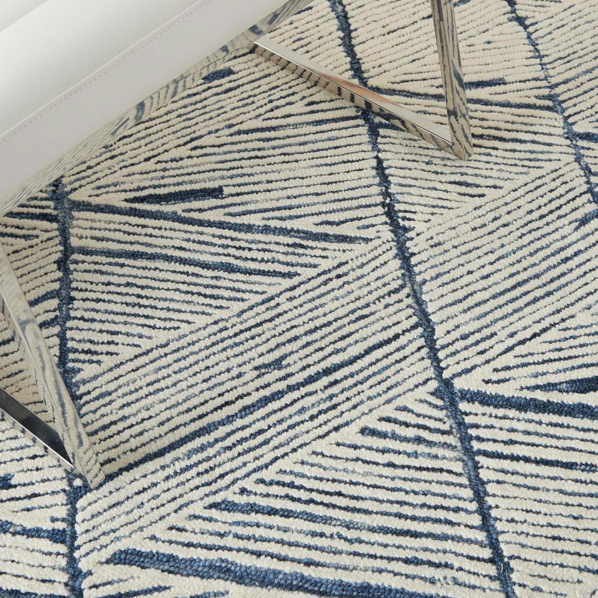 Elegant navy and cream geometric area rug for stylish home decor.