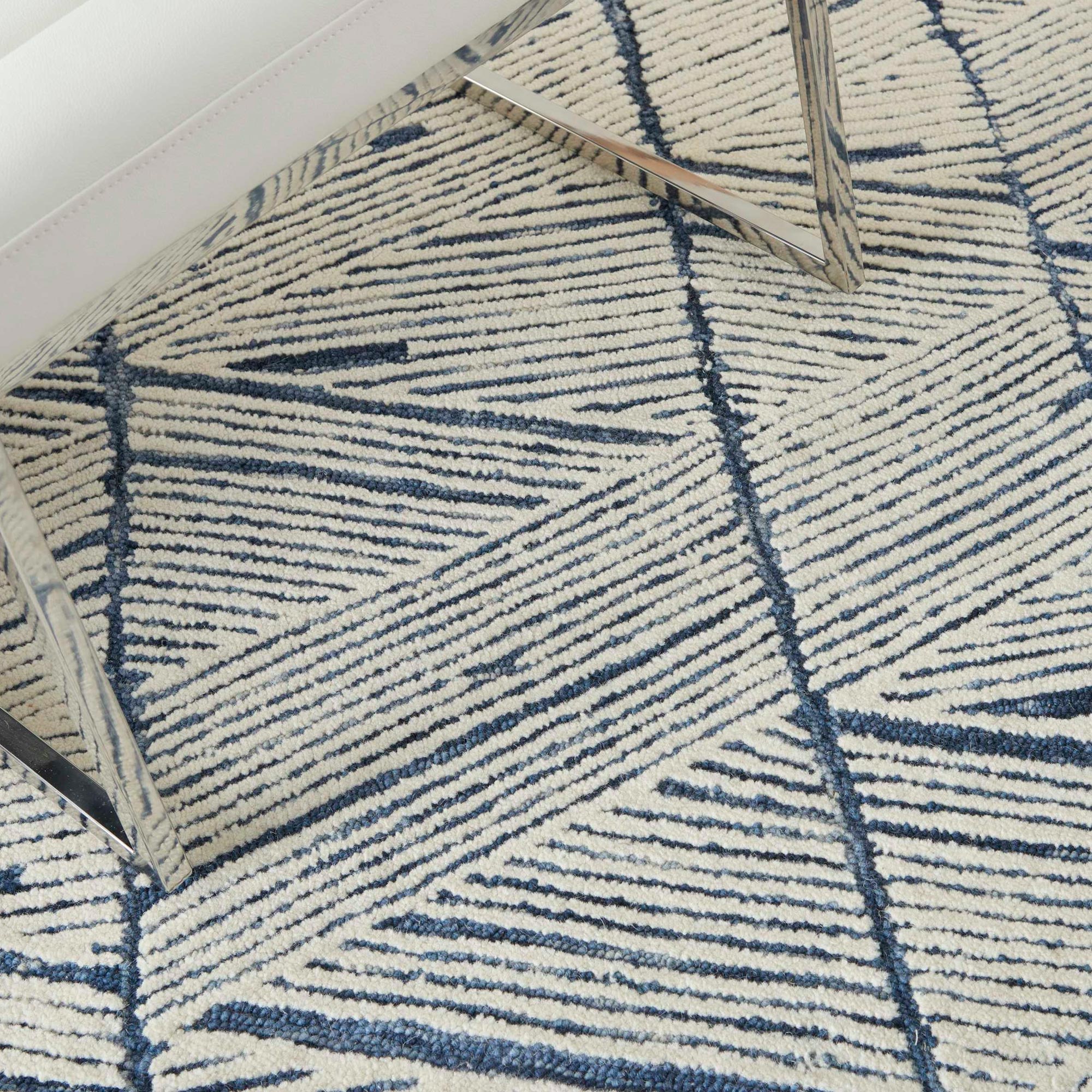 Elegant navy and cream geometric area rug for stylish home decor.