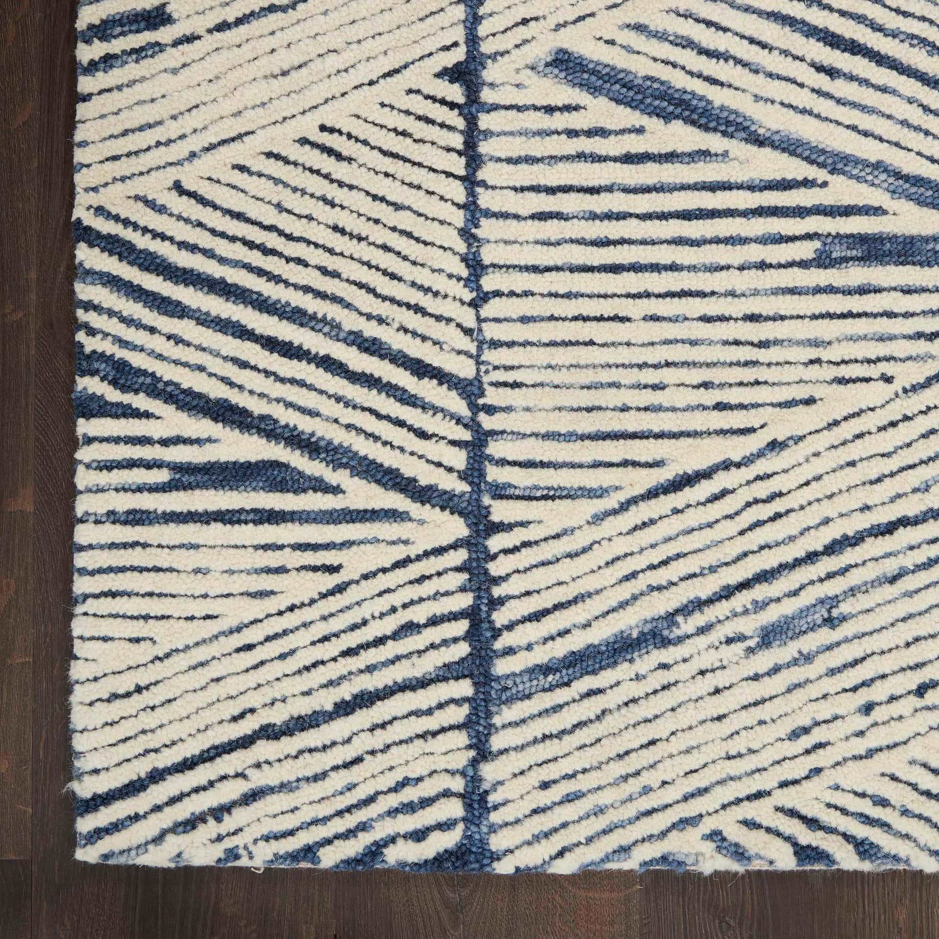 Contemporary blue and white geometric rug with bold lines and patterns.