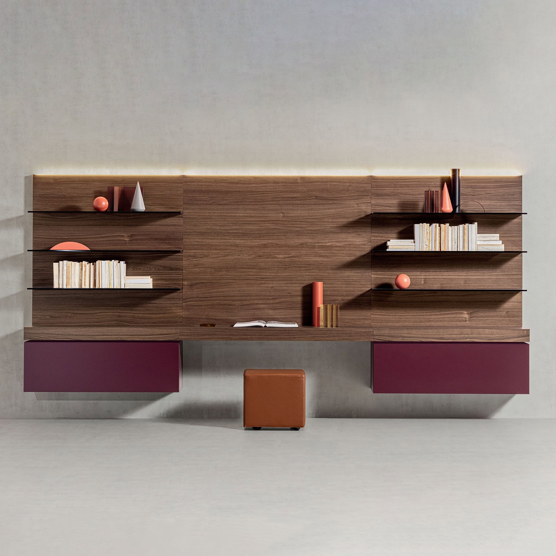 Contemporary walnut and purple wall-mounted shelving with books and decor.