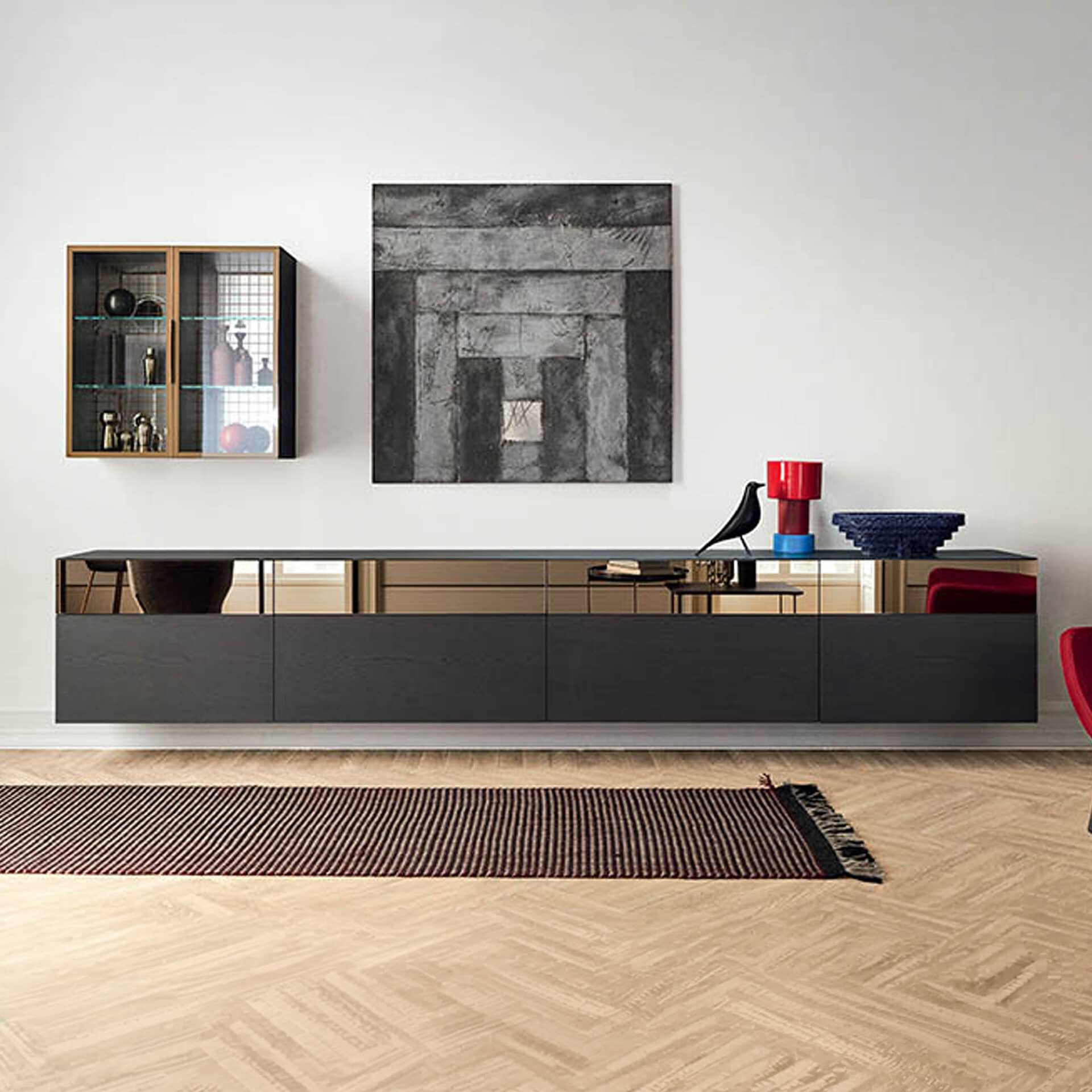 Modern minimalist living room with sleek black sideboard and abstract wall art.