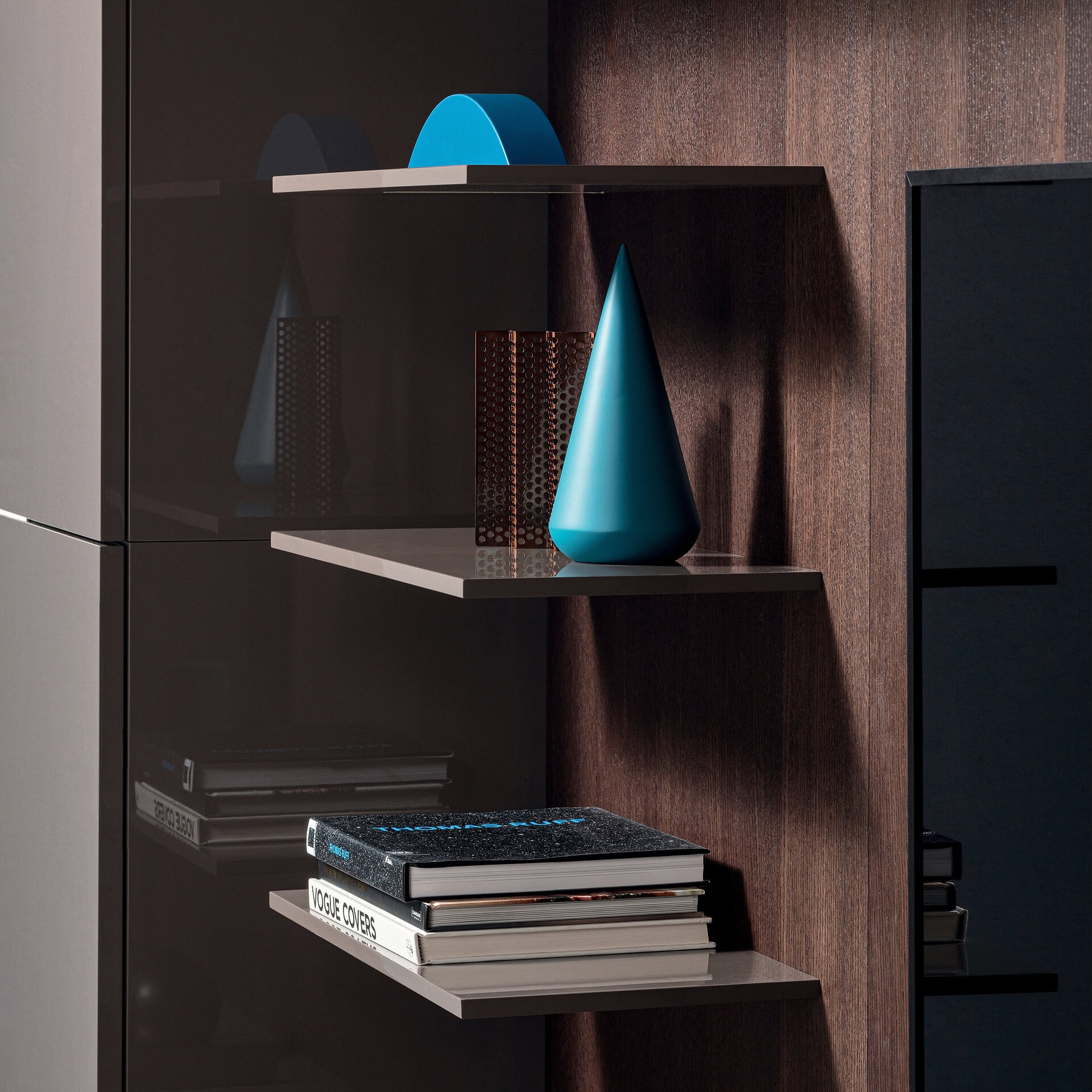 Stylish modern shelves with blue cone vase and decorative objects.
