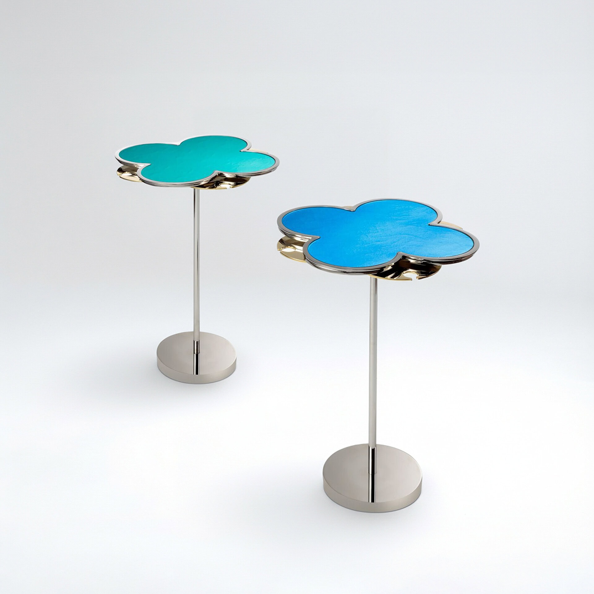 Modern cloud-shaped side tables with colorful tops and sleek metal bases.