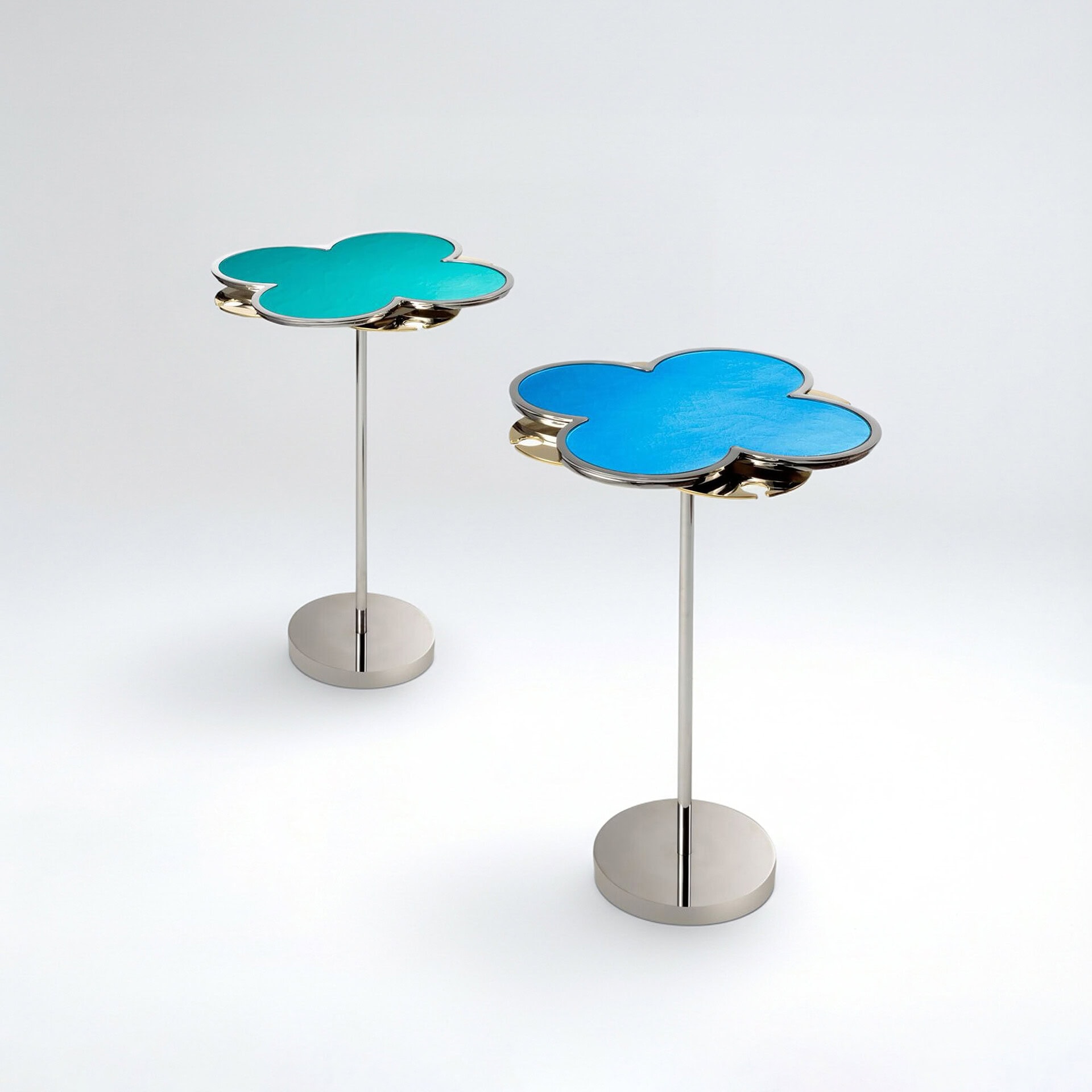 Modern cloud-shaped side tables with colorful tops and sleek metal bases.