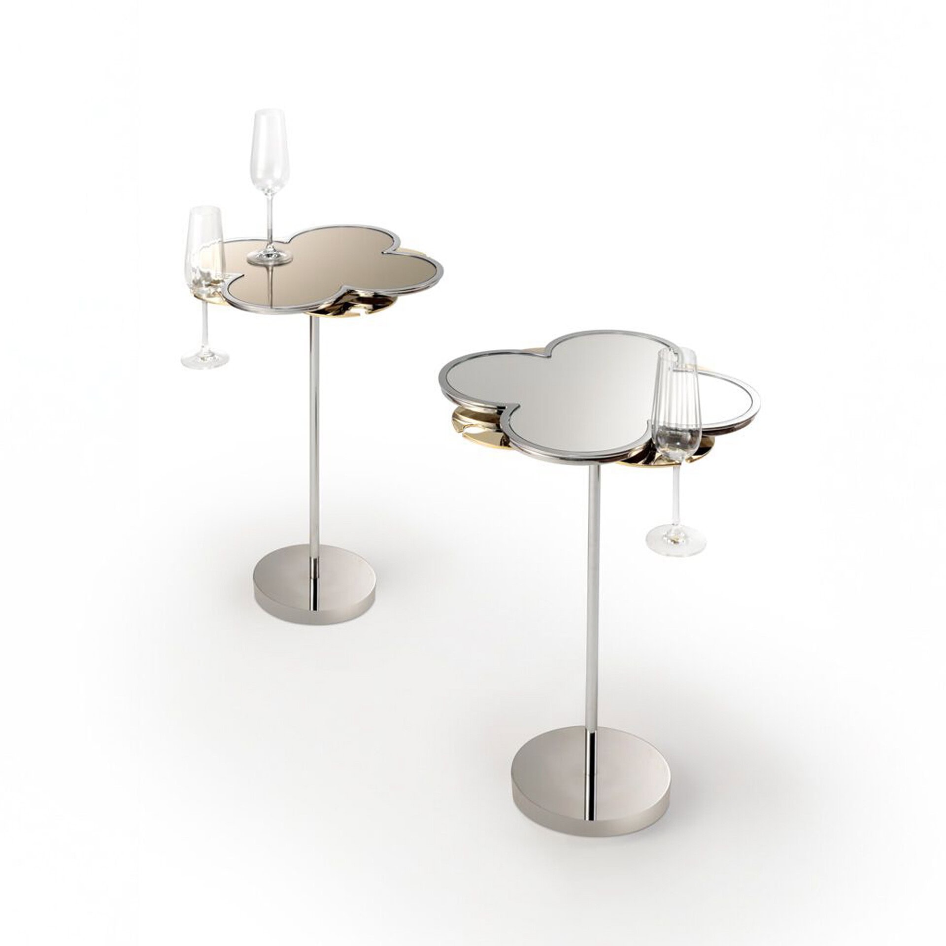 Modern cloud-shaped side tables with reflective surfaces and glassware.