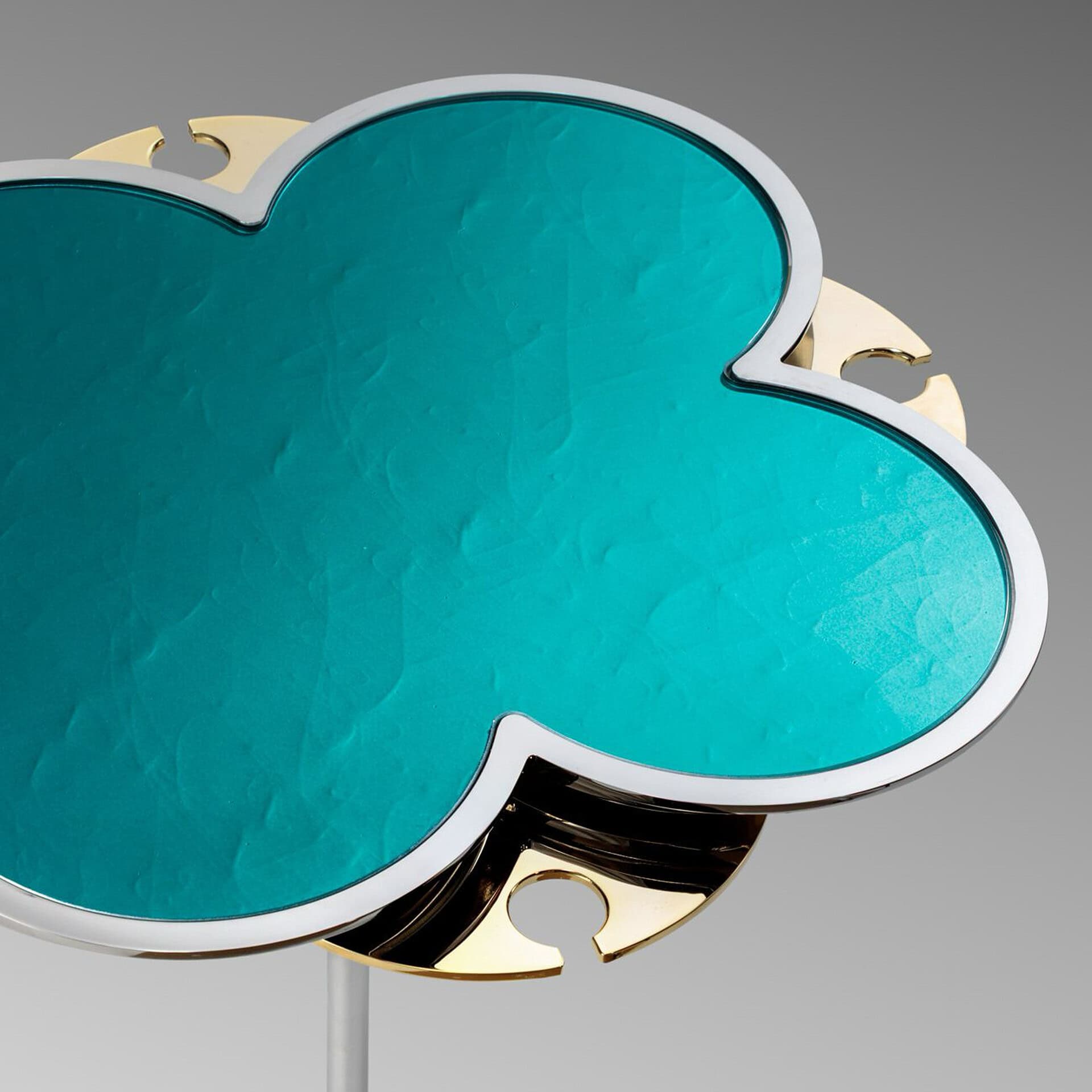 Decorative cloud-shaped object featuring teal color and gold accents, ideal for modern interior deco.