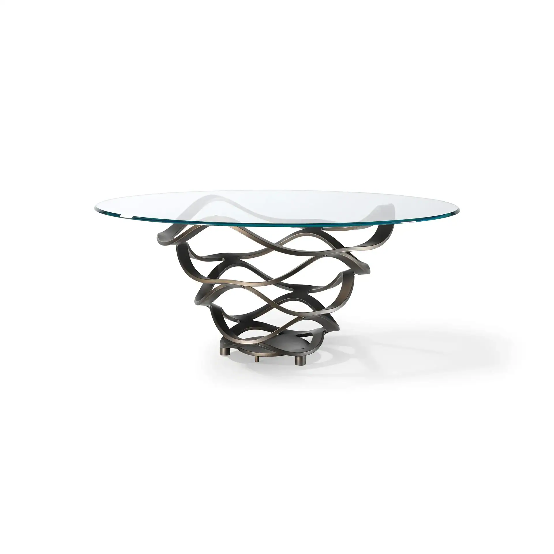 A modern round coffee table with a clear glass top and a dark bronze, wavy, sculptural metal base on a white background.