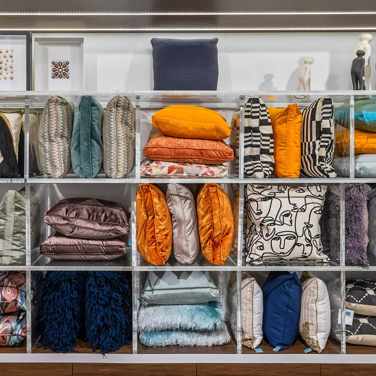 Brightly colored cushions and accessories displayed in retail store.
