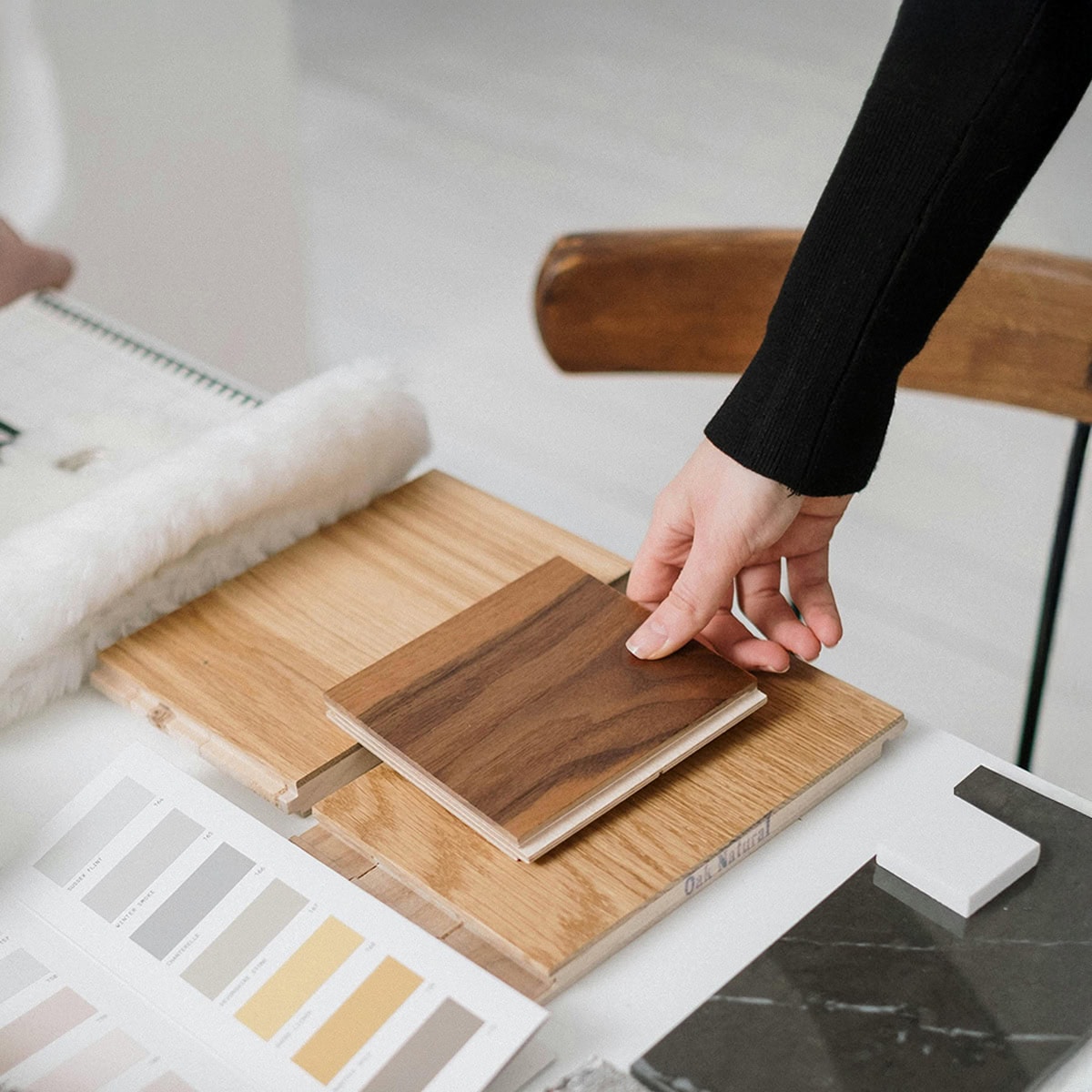 Wood sample swatch on a table for furniture design and material selection.