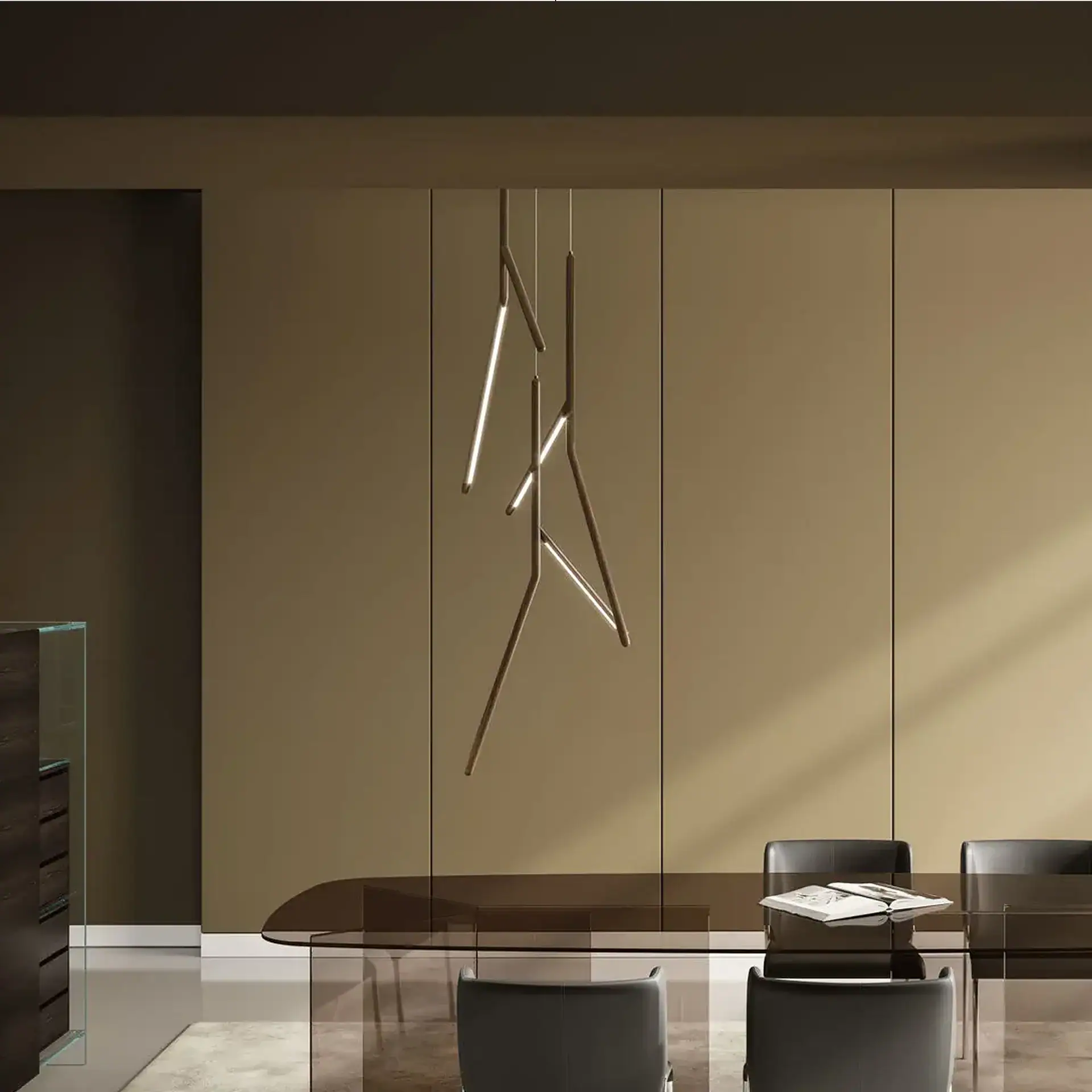 A modern dining room with a smoked glass table, dark chairs, and a sculptural linear chandelier hanging from the ceiling. The walls are two-toned beige and brown.