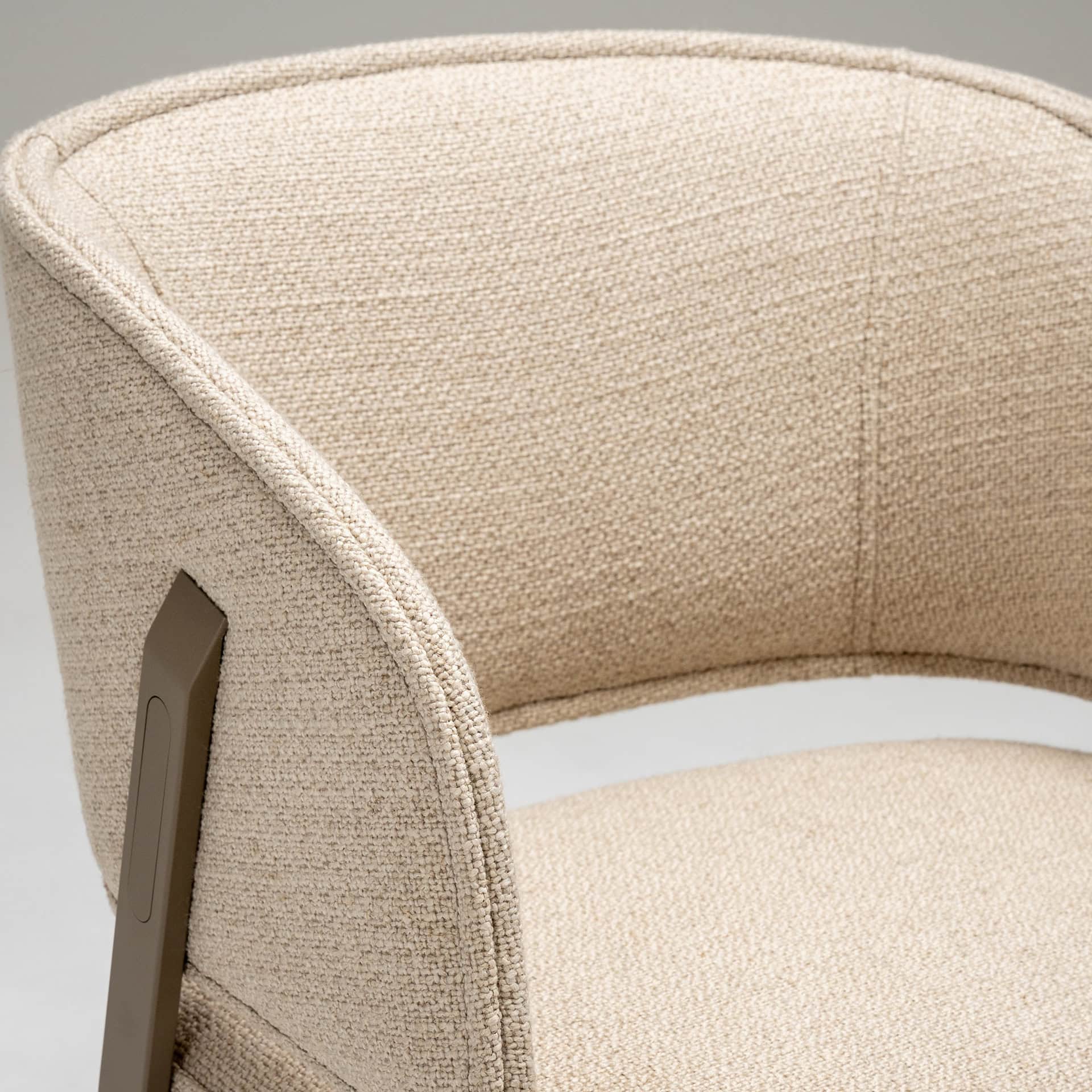 Elegant beige upholstered armchair with sleek design and sturdy frame.