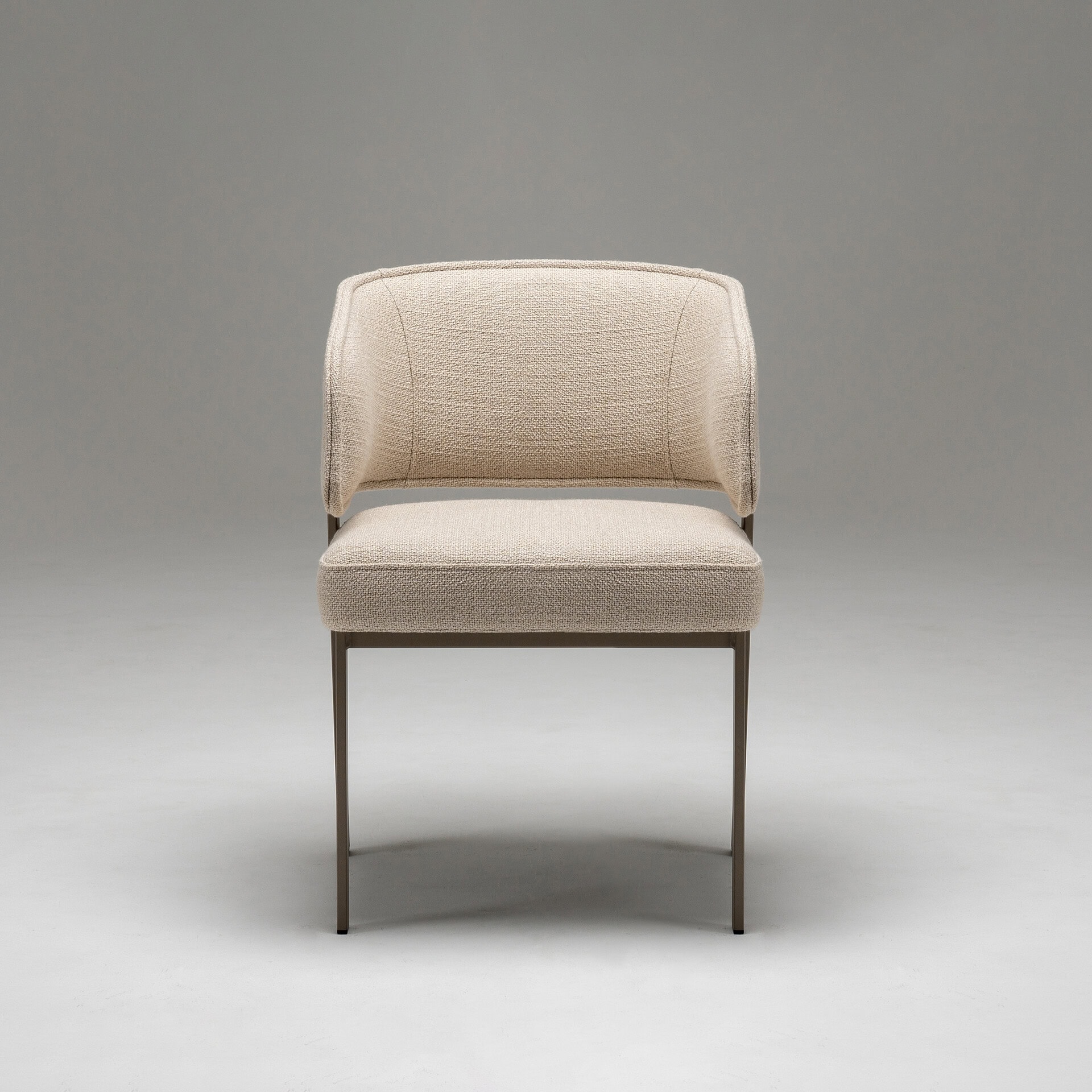 Elegant beige upholstered dining chair with metal legs for contemporary dining rooms.