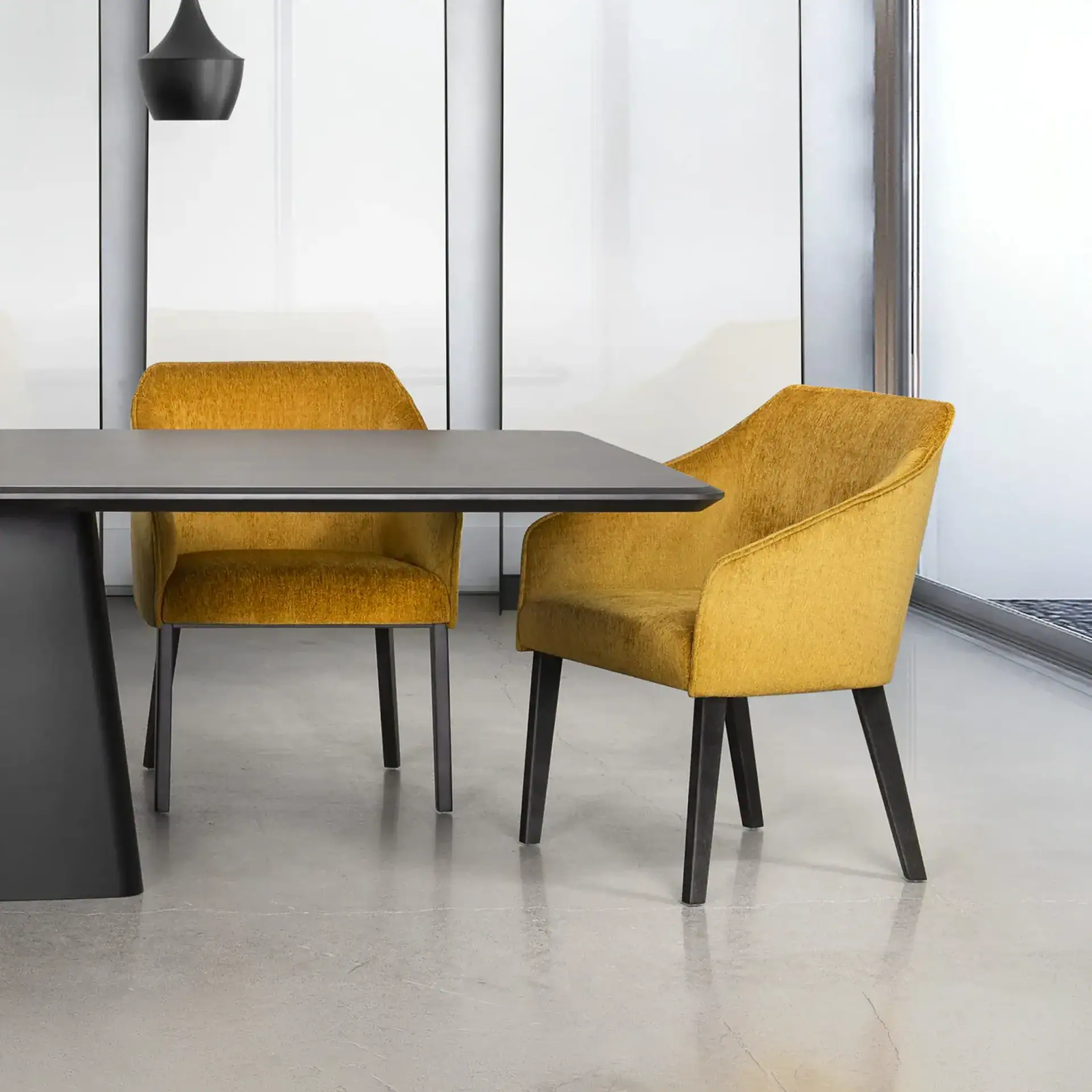 Contemporary yellow upholstered dining chairs with black legs in a modern office setting.