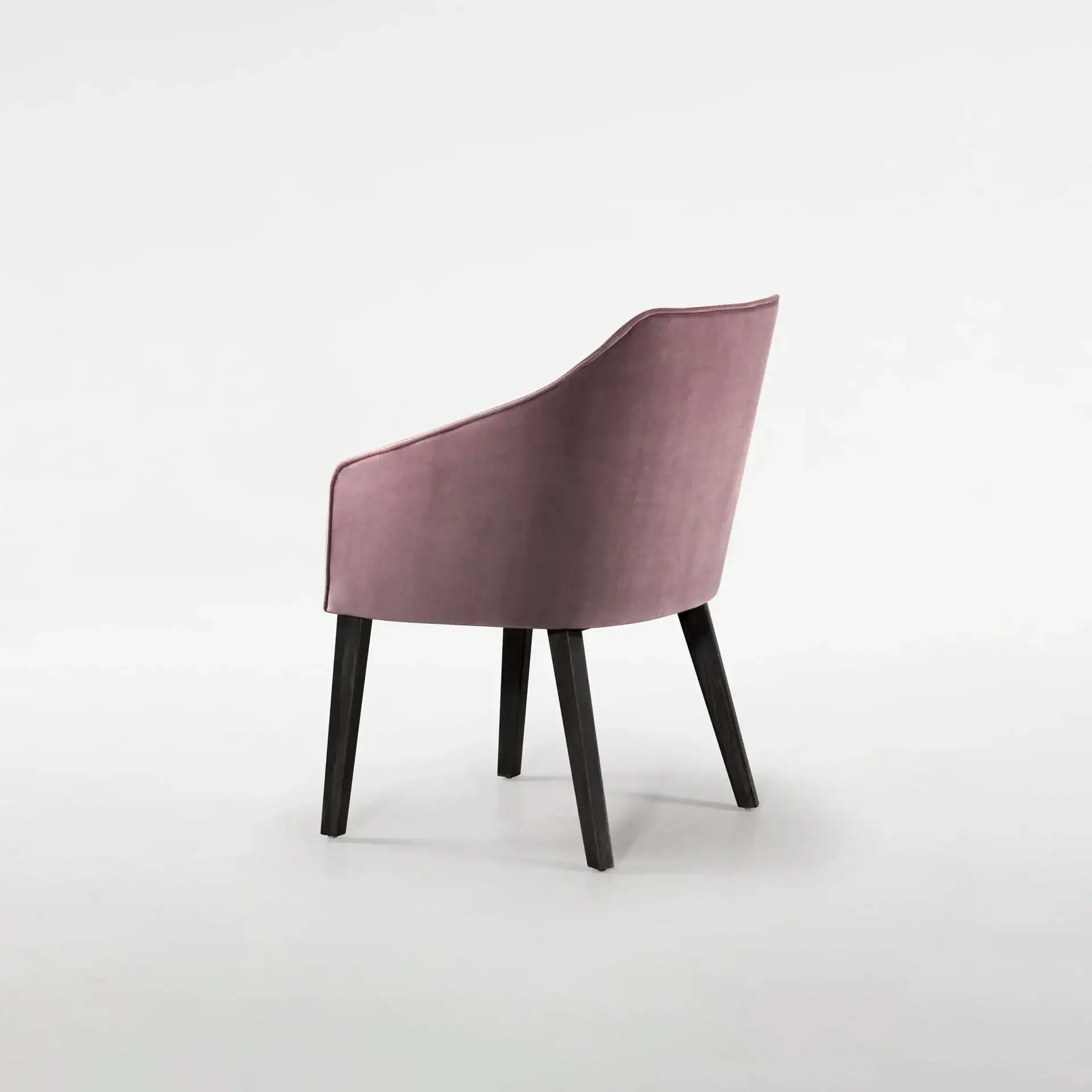 Pink upholstered accent chair with black wooden legs, modern design, perfect for living room or offi.