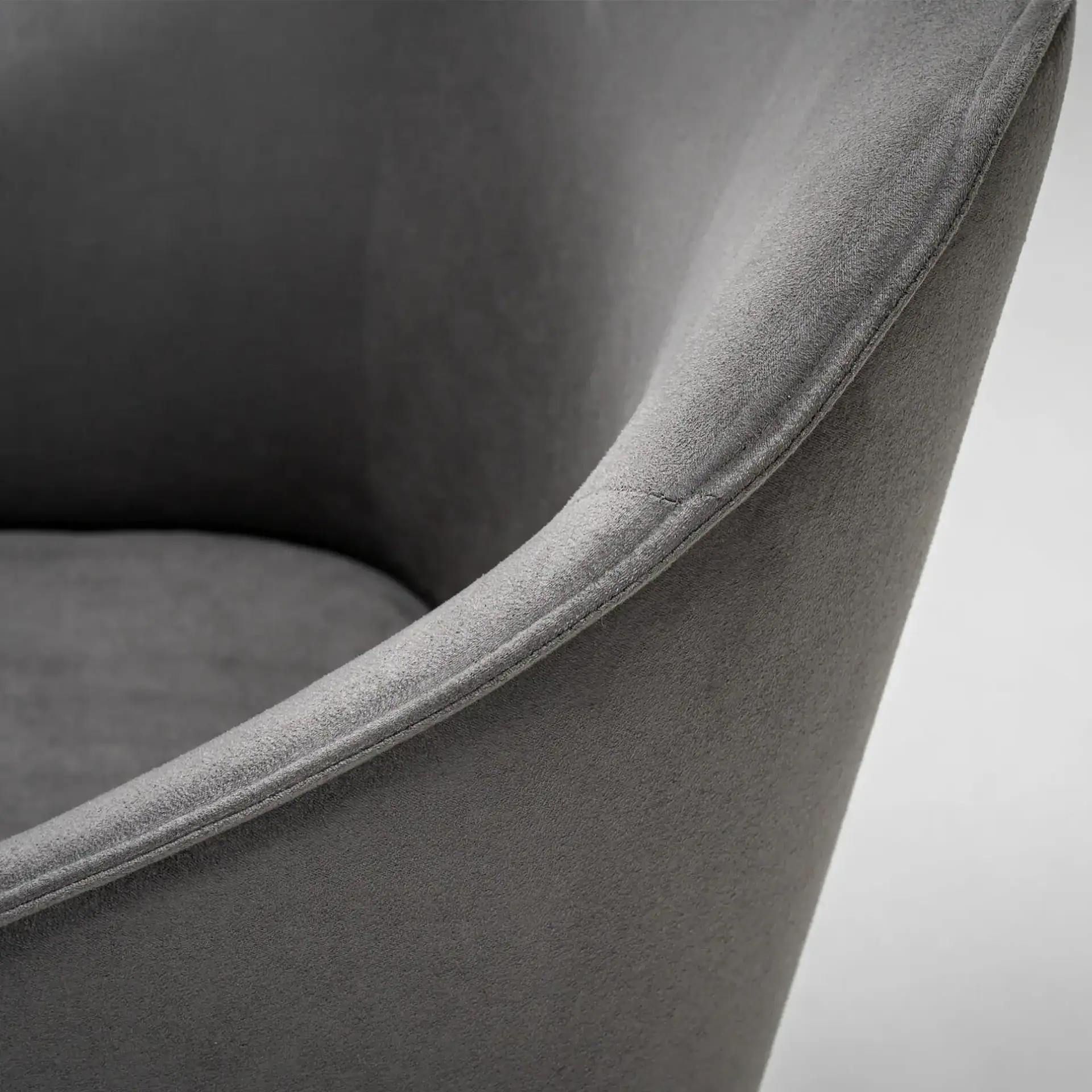 Modern gray upholstered armchair with sleek design and plush fabric.