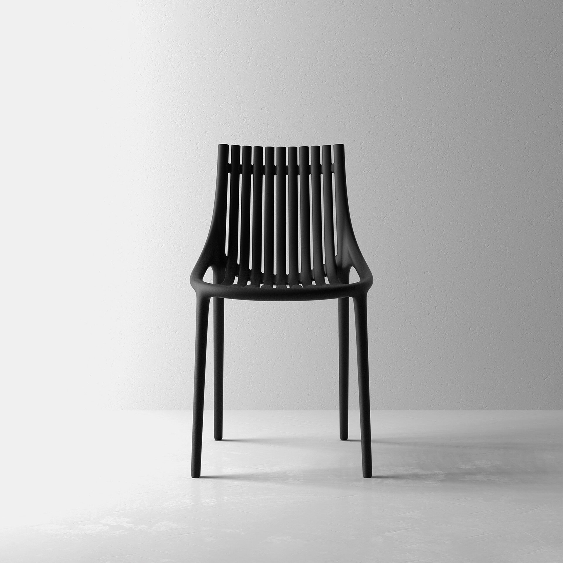 Black slatted chair with sleek design on a plain wall background.