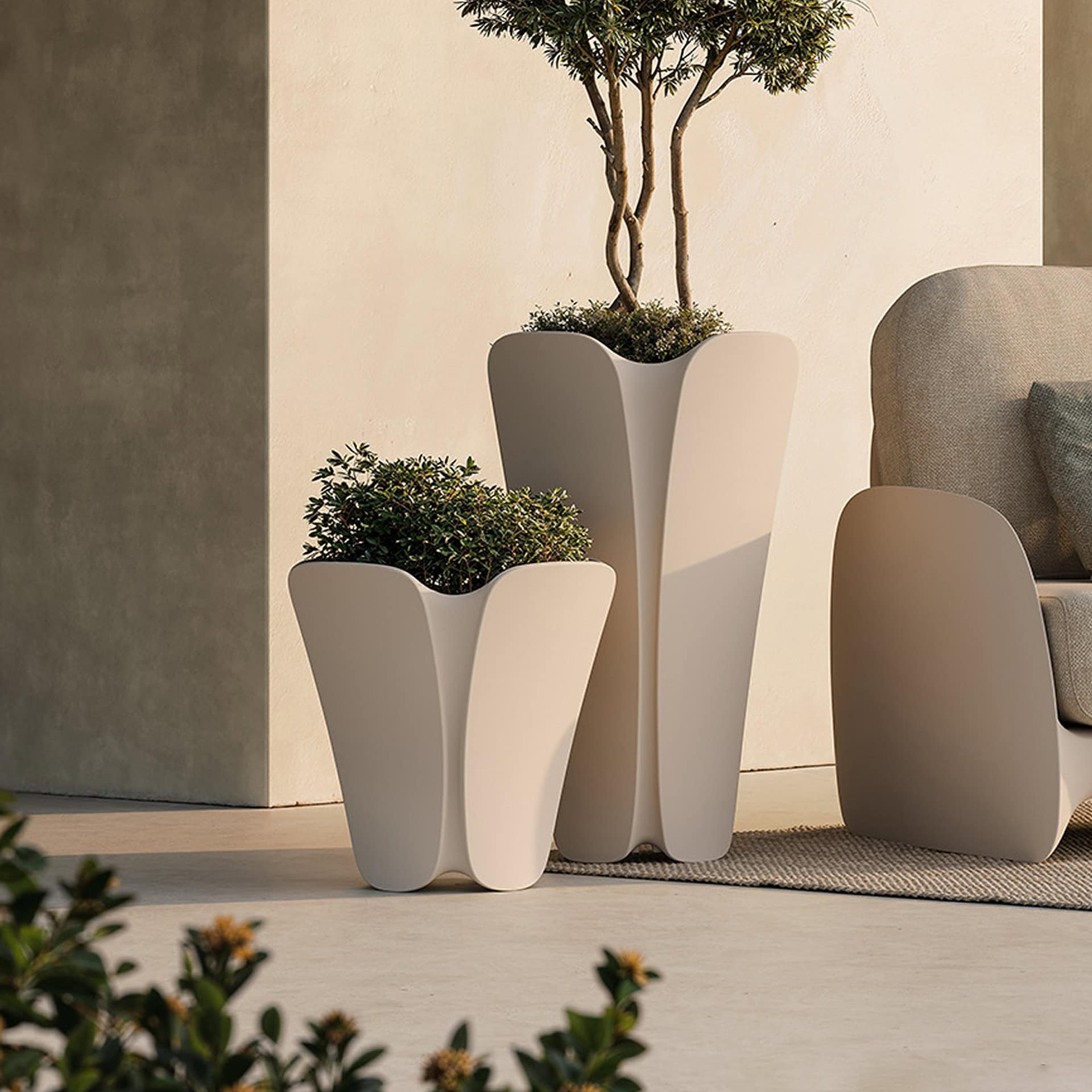 Stylish outdoor planters with lush greenery, perfect for modern patio decor.