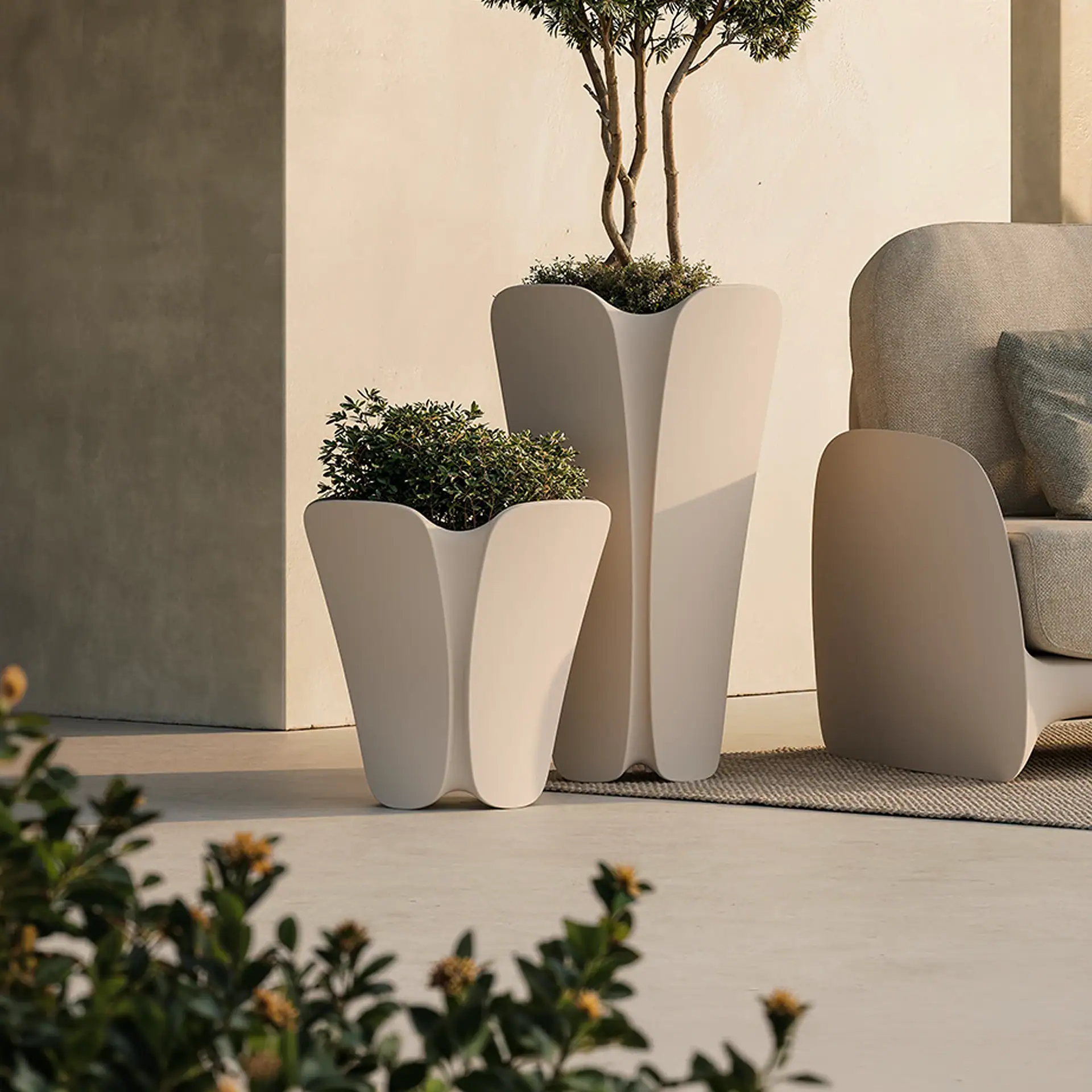 Stylish outdoor planters with lush greenery, perfect for modern patio decor.