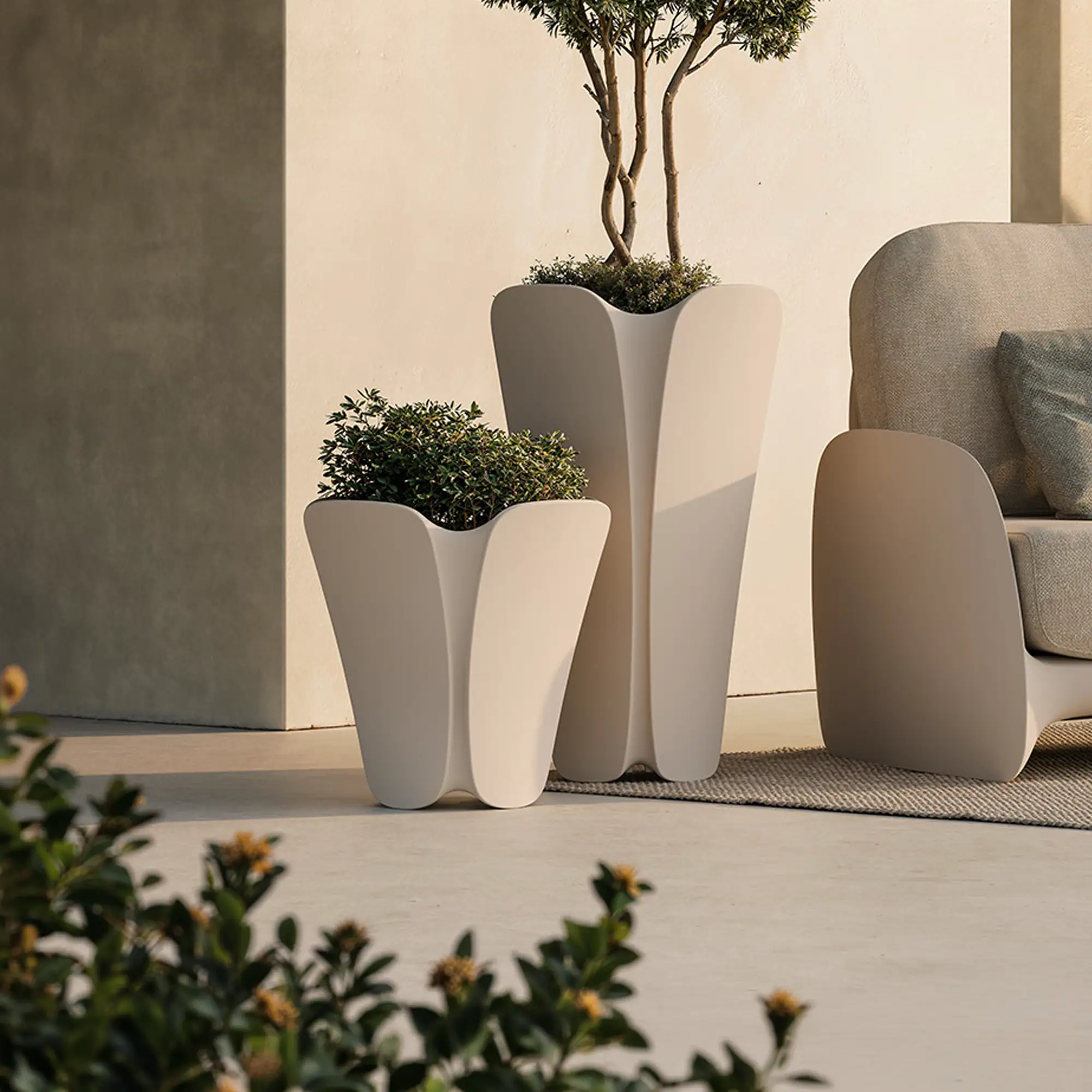 Stylish outdoor planters with lush greenery, perfect for modern patio decor.