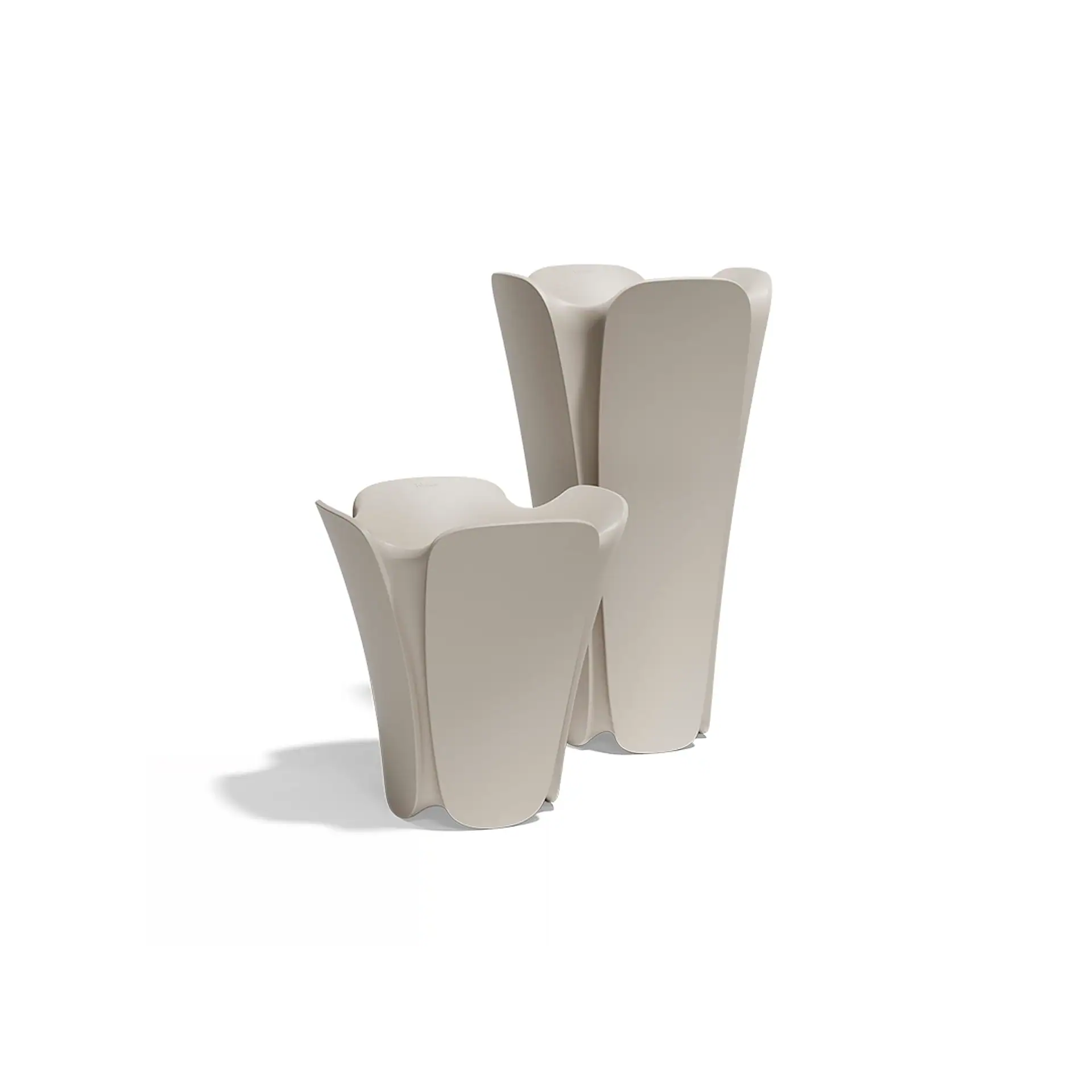 Two light beige, flower-shaped planters, one short and one tall, on a white background.