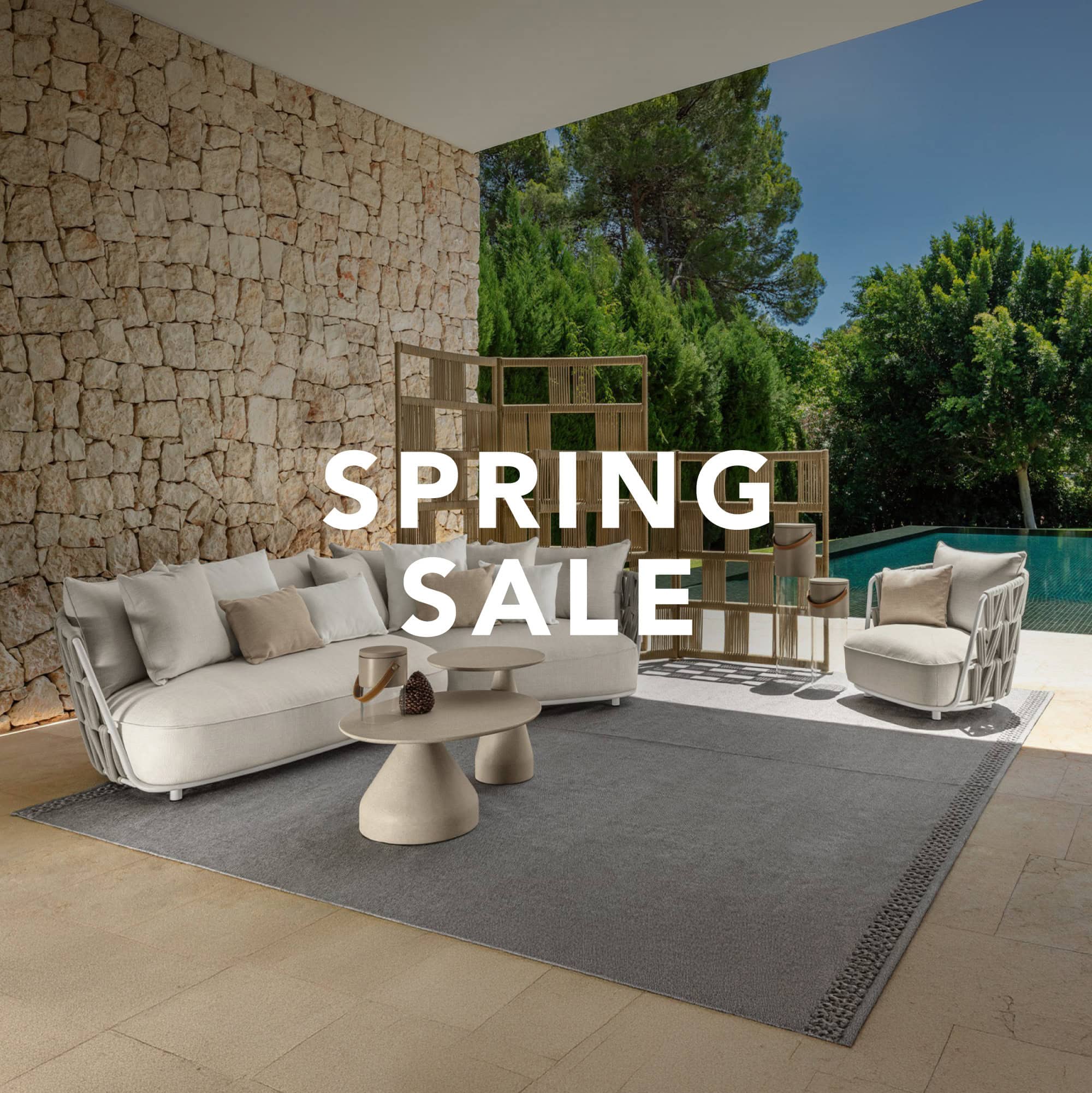 Outdoor furniture set with sofa, chairs, and coffee table on patio during spring sale event.