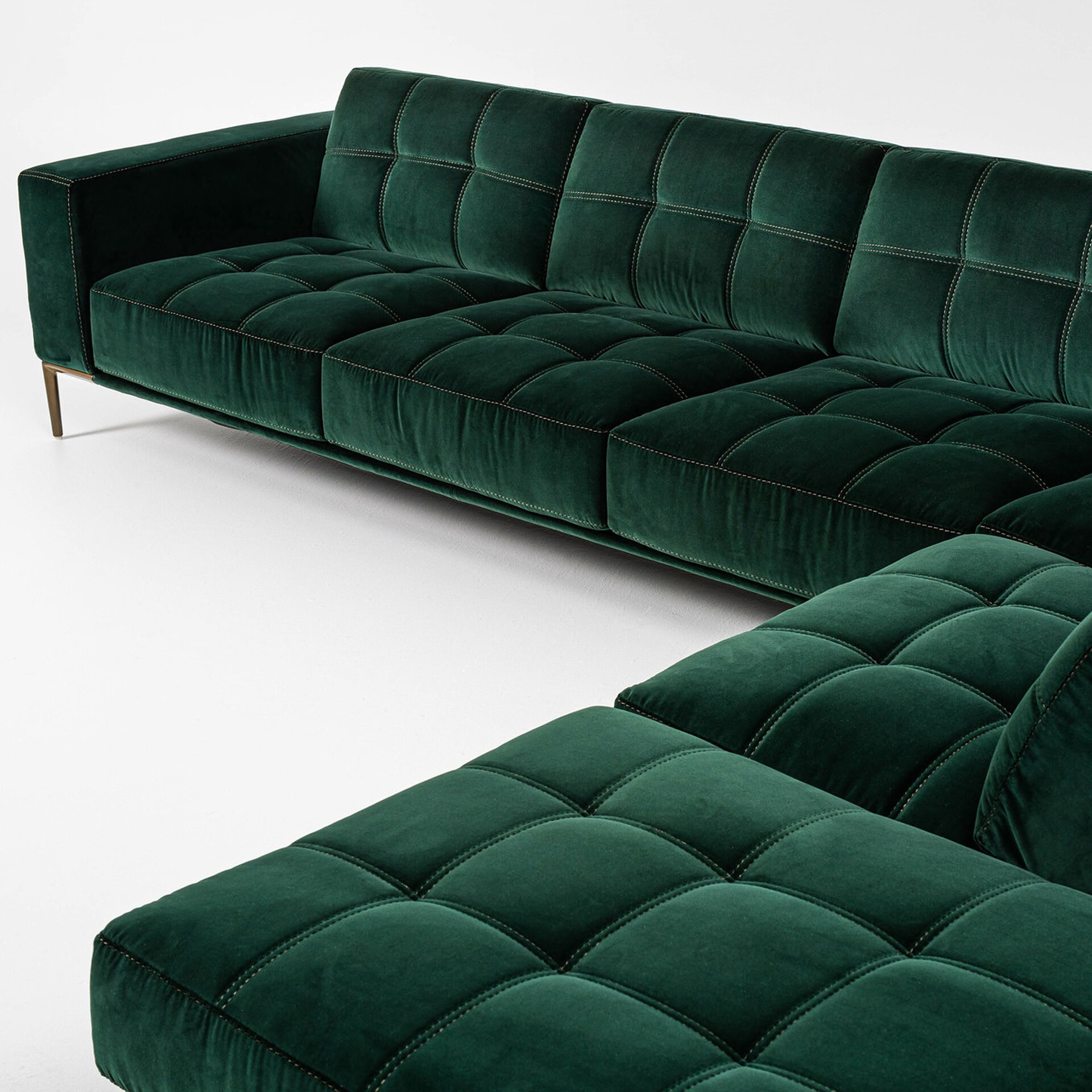 Elegant green velvet Barcelona sectional sofa with tufted cushions and sleek design.