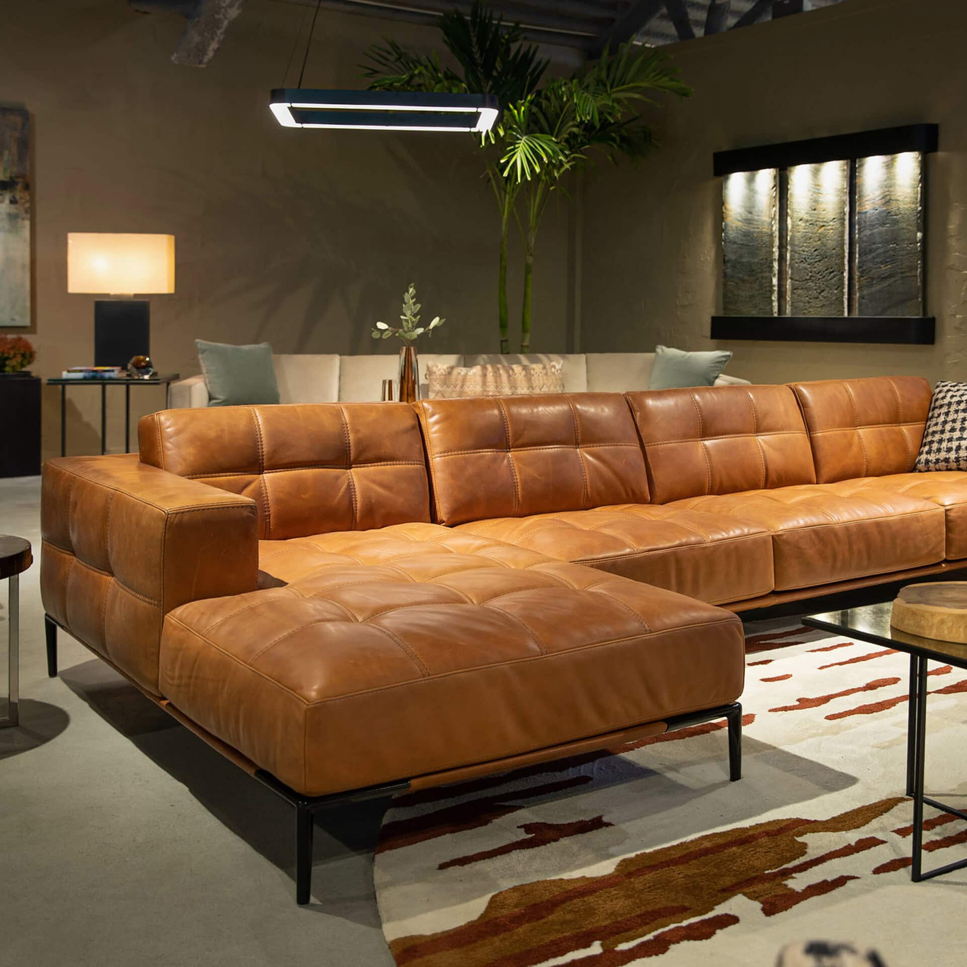 Elegant leather sectional sofa with chaise lounge in contemporary living room.