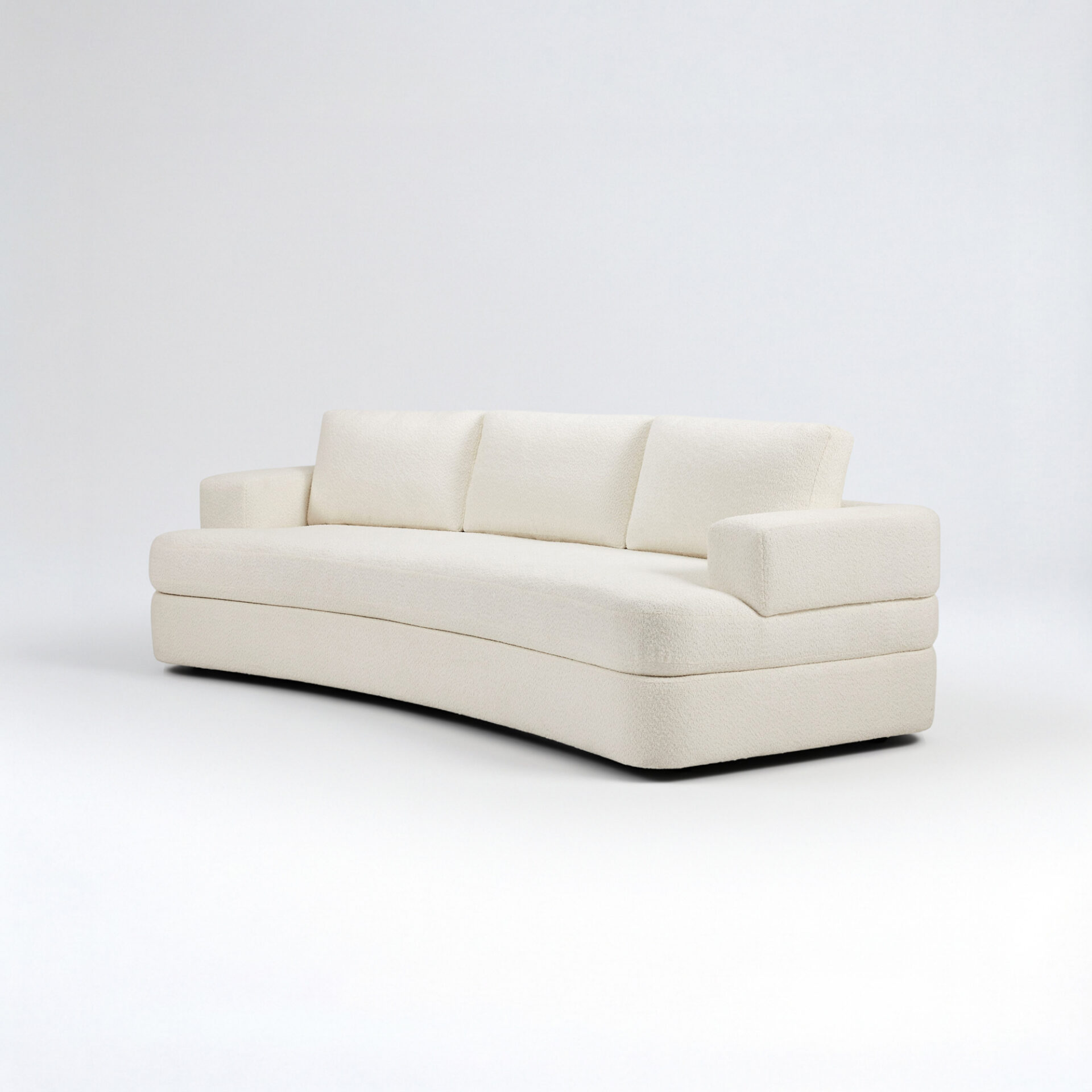 A cream-colored, curved sofa with textured upholstery against a white background.