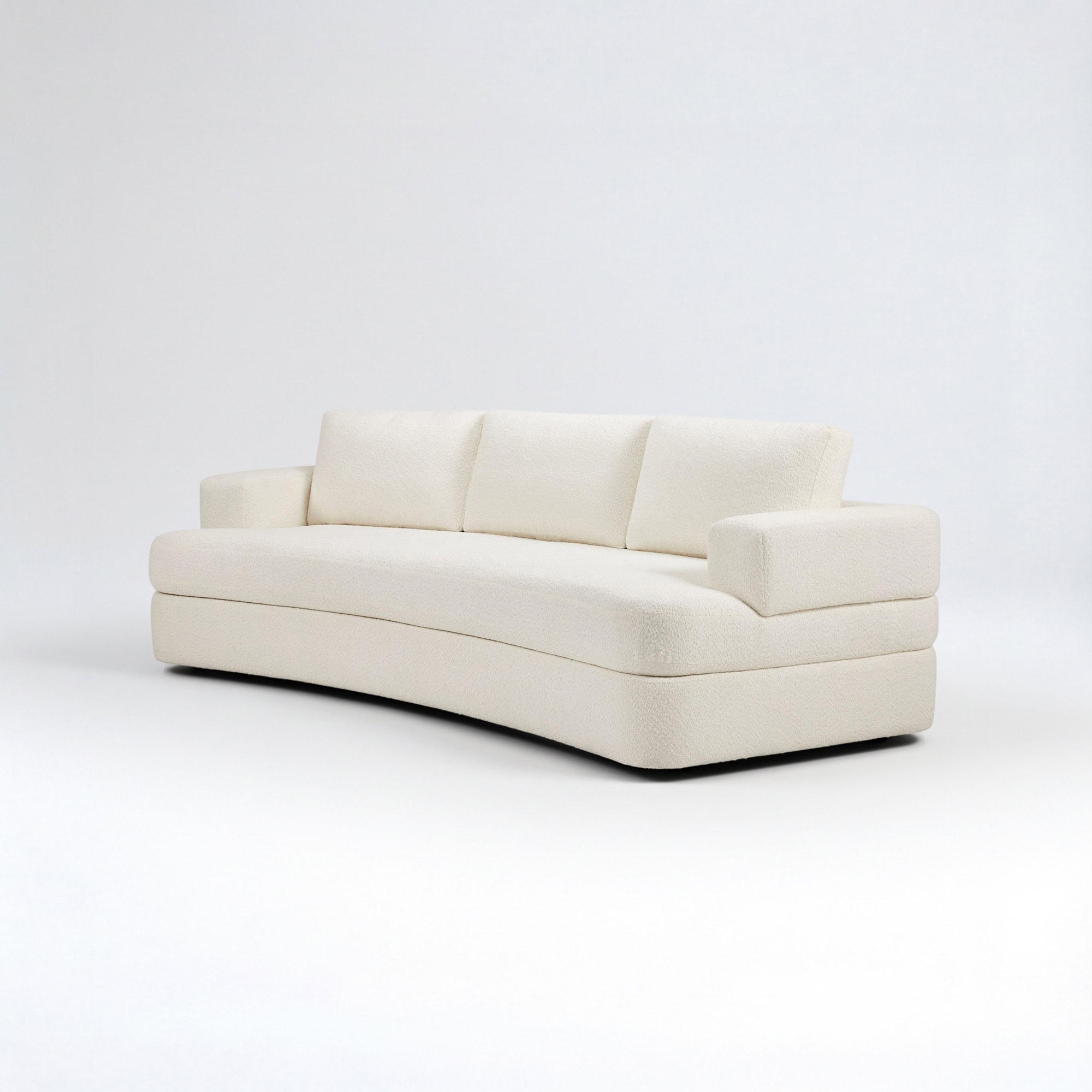 A cream-colored, curved sofa with textured upholstery against a white background.