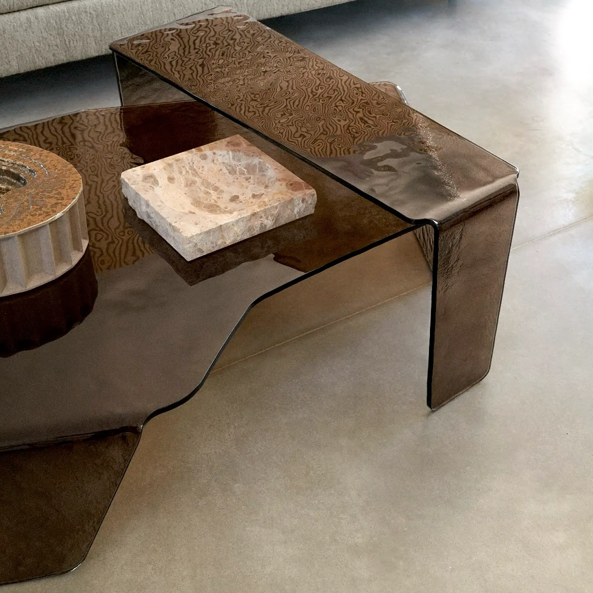 Sklar Furnishings Chimera hammered glass coffee table in a modern living room.