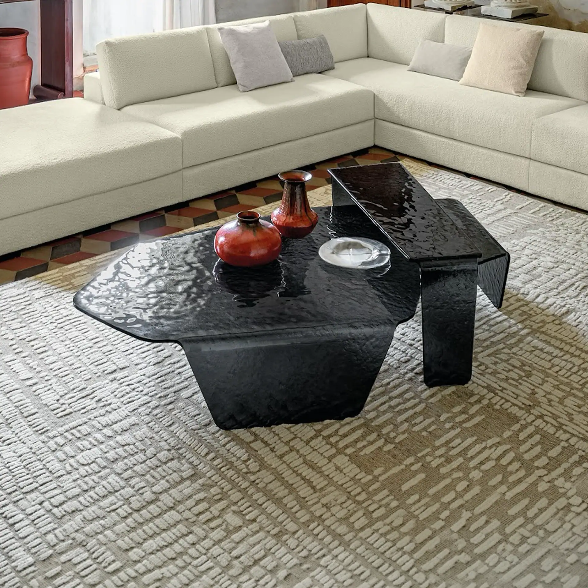 Chimera hammered glass coffee table with black finish in living room setting.