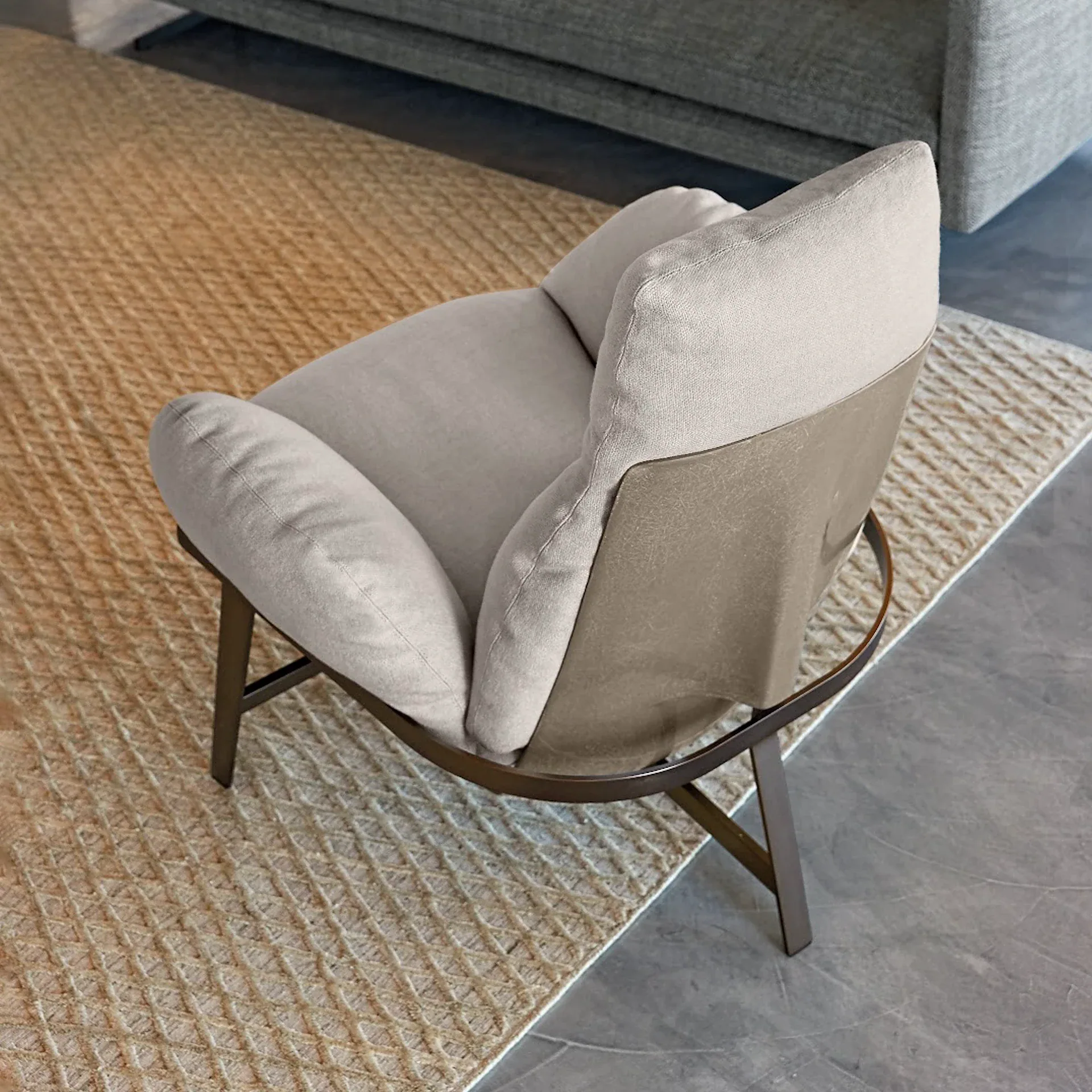 Sklar Furnishings lounge chair with soft beige upholstery and curved metal frame.