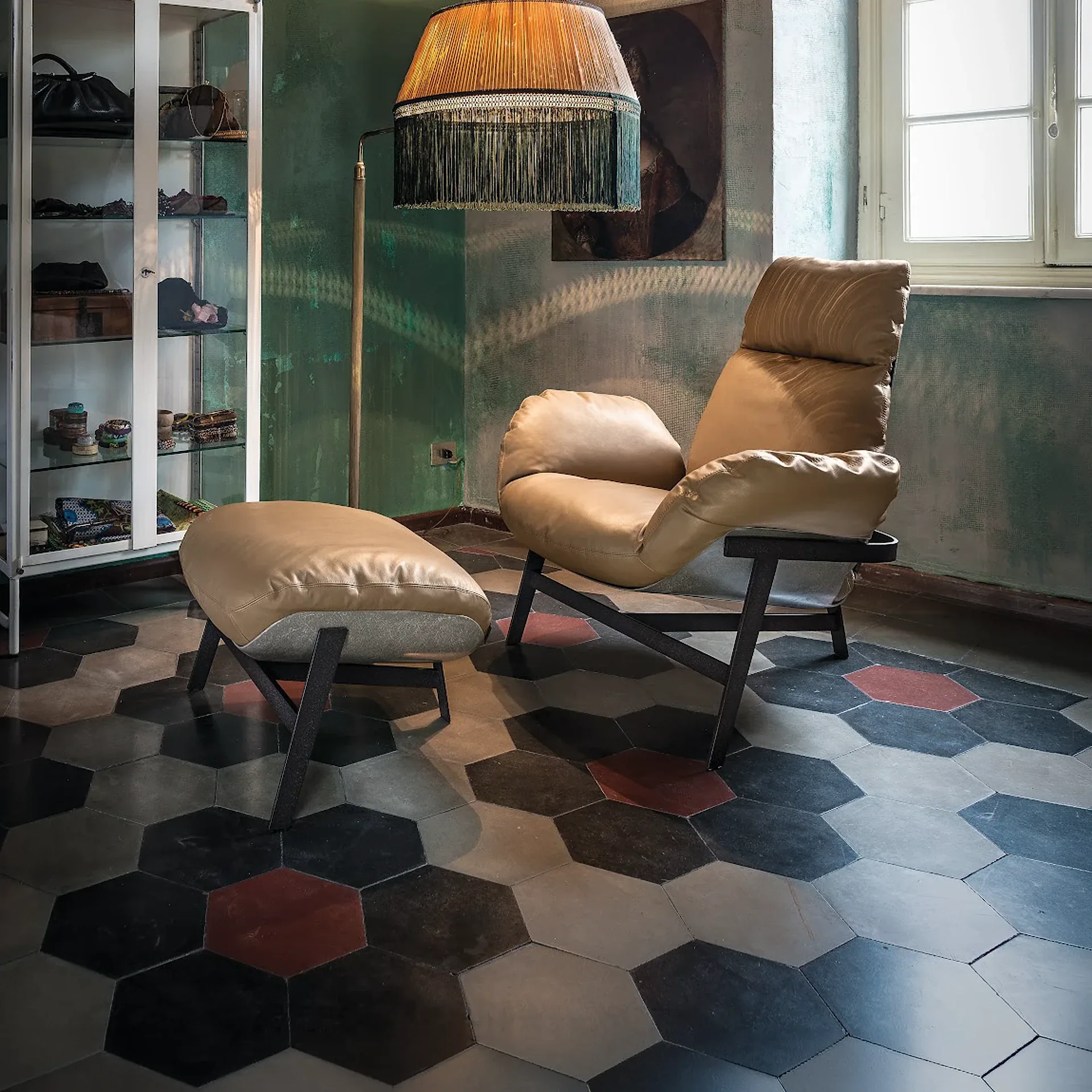 Sklar Furnishings lounge chair in a sunlit room with hex tile floor.